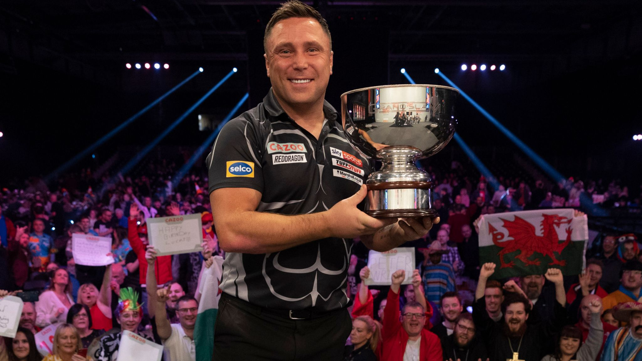 Gerwyn Price poses with the 2021 Grand Slam of Darts trophy