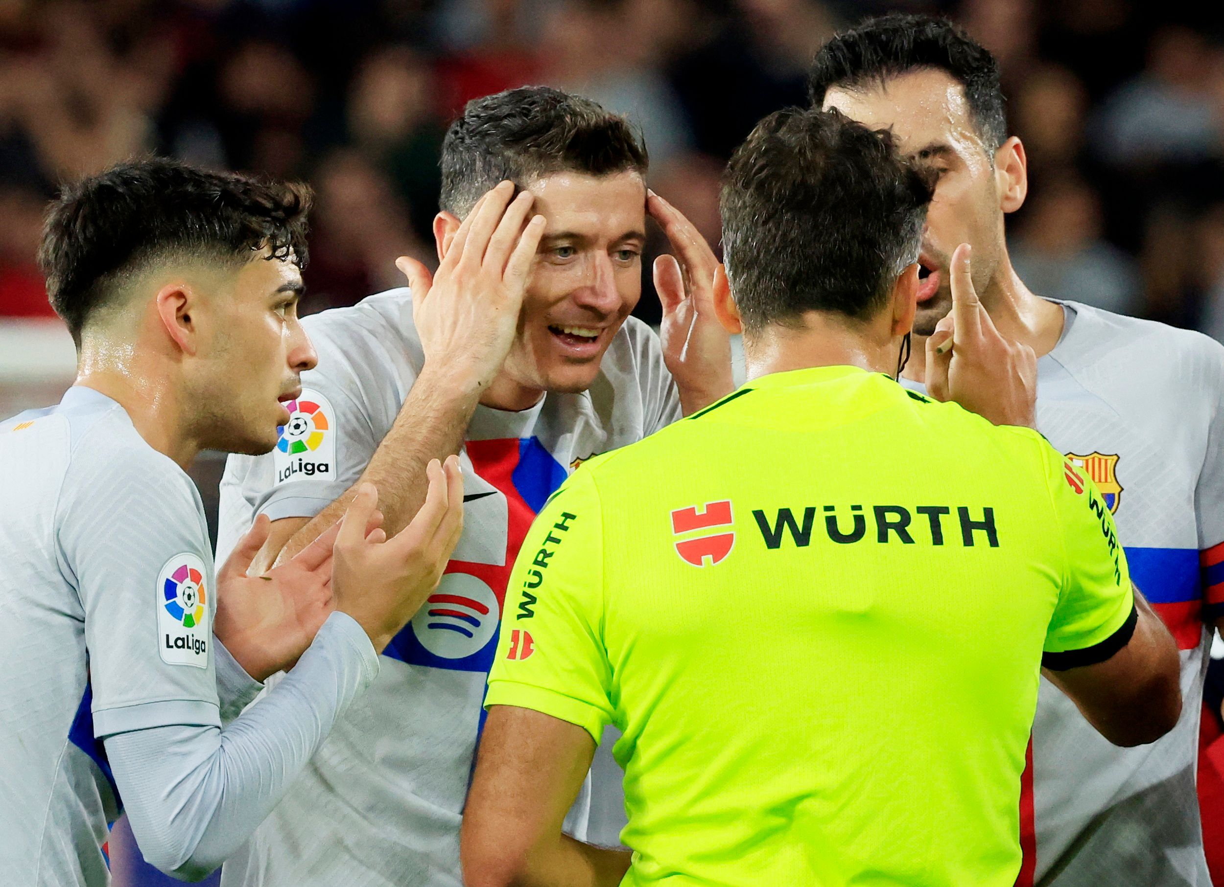 Robert Lewandowski argues with the referee after being sent off