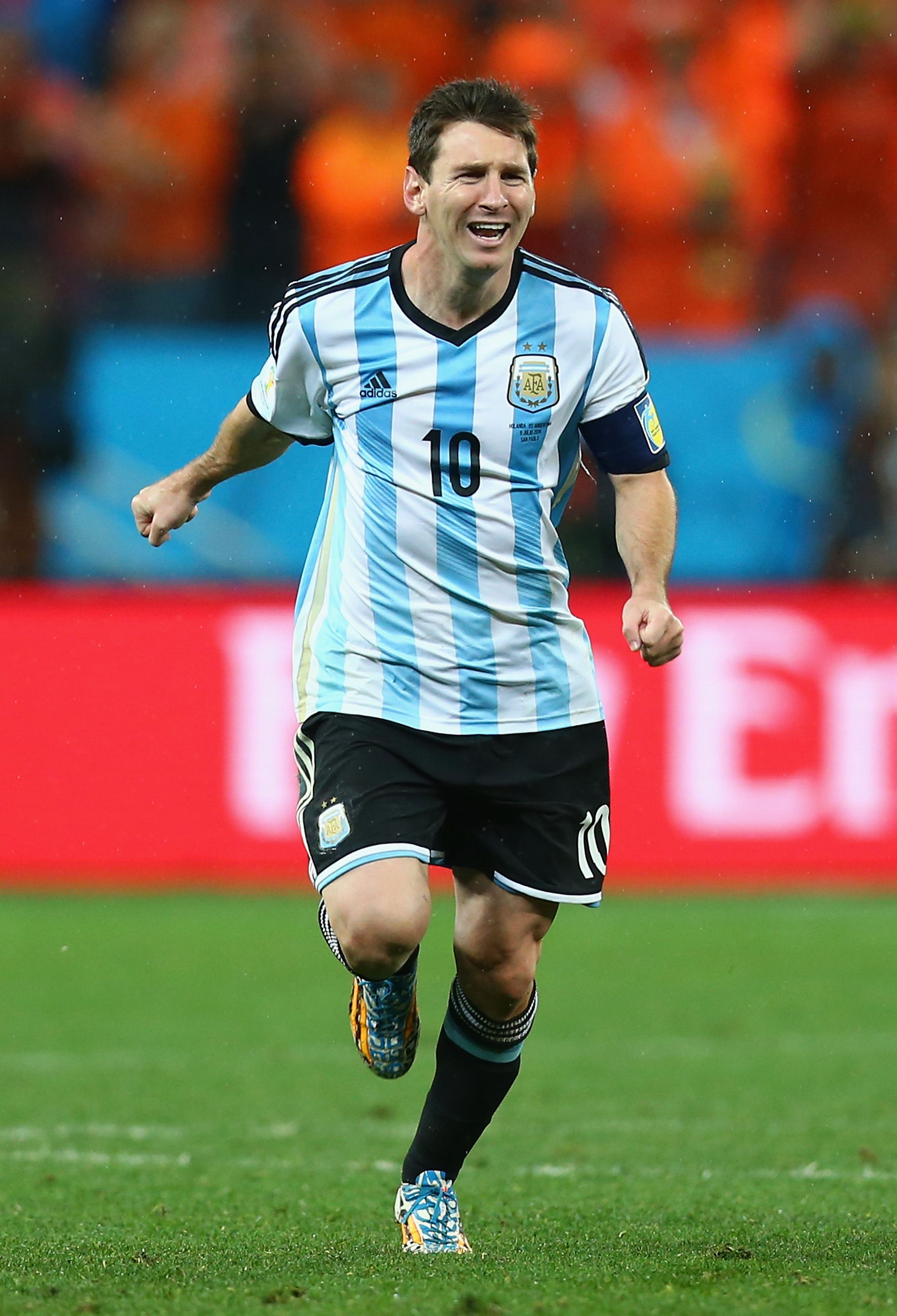 Messi celebrates beating the Netherlands at the 2014 World Cup.