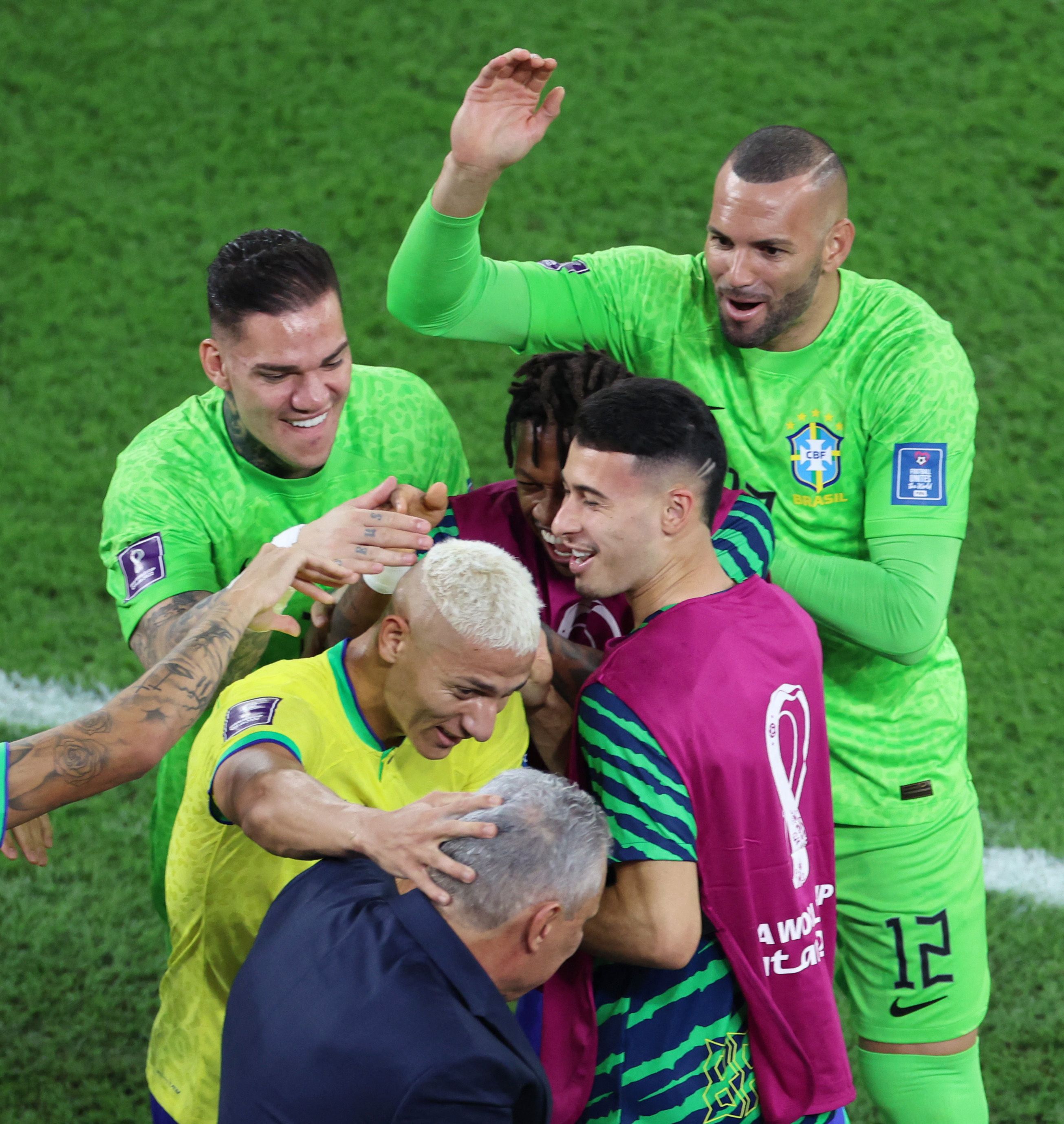 Brazil players celebrate with Tite.