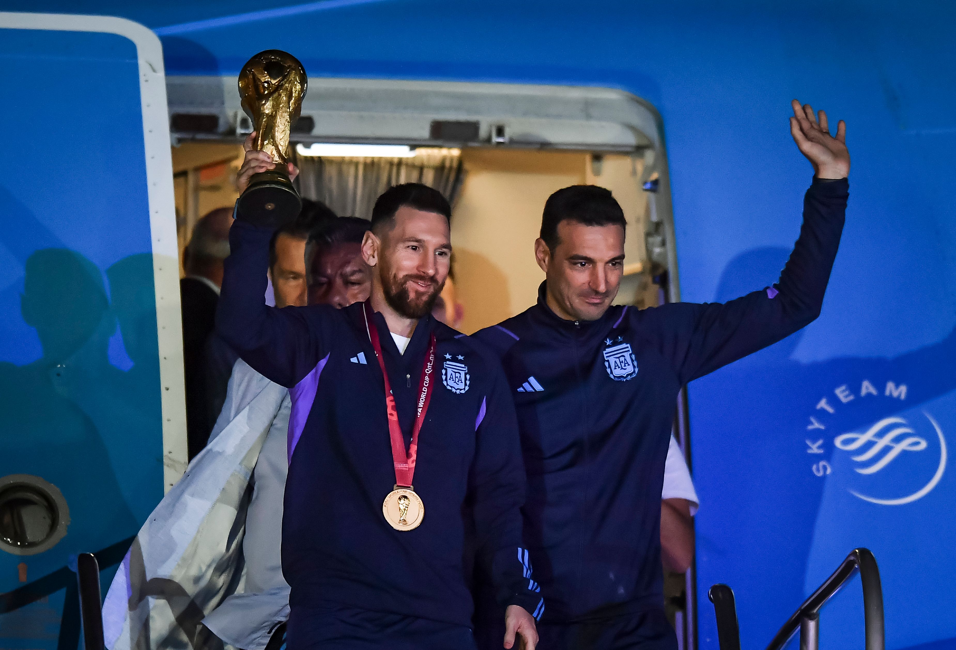 Lionel Messi of Argentina (L) and Lionel Scaloni (R) holds the FIFA World Cup during the arrival of the Argentina men's national football team after winning the FIFA World Cup Qatar 2022 on December 20, 2022 in Buenos Aires, Argentina.
