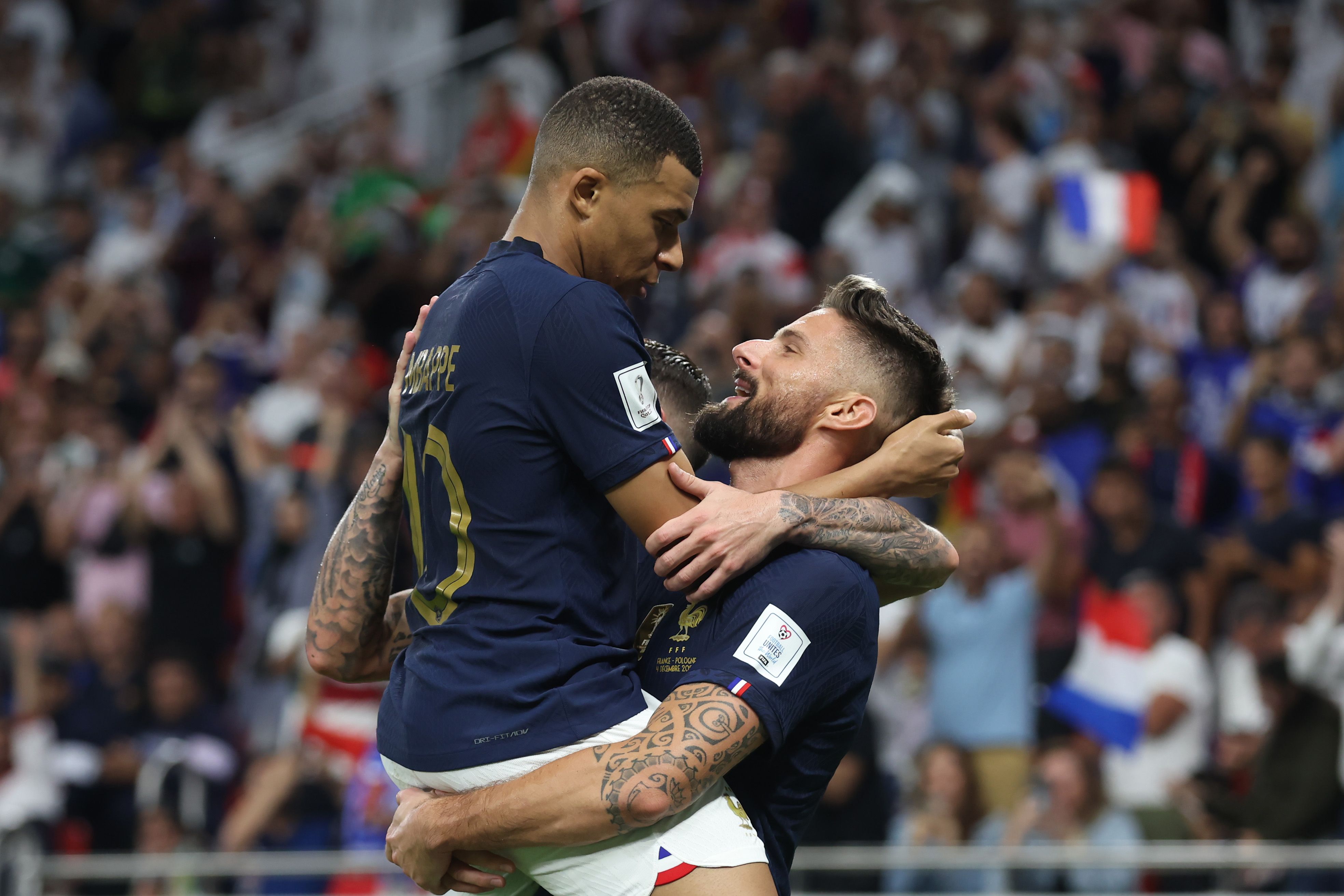Olivier Giroud of France celebrates with teammates Kylian Mbappe after scoring the team's first goal during the FIFA World Cup Qatar 2022 Round of 16 match between France and Poland at Al Thumama Stadium on December 04, 2022 in Doha, Qatar.