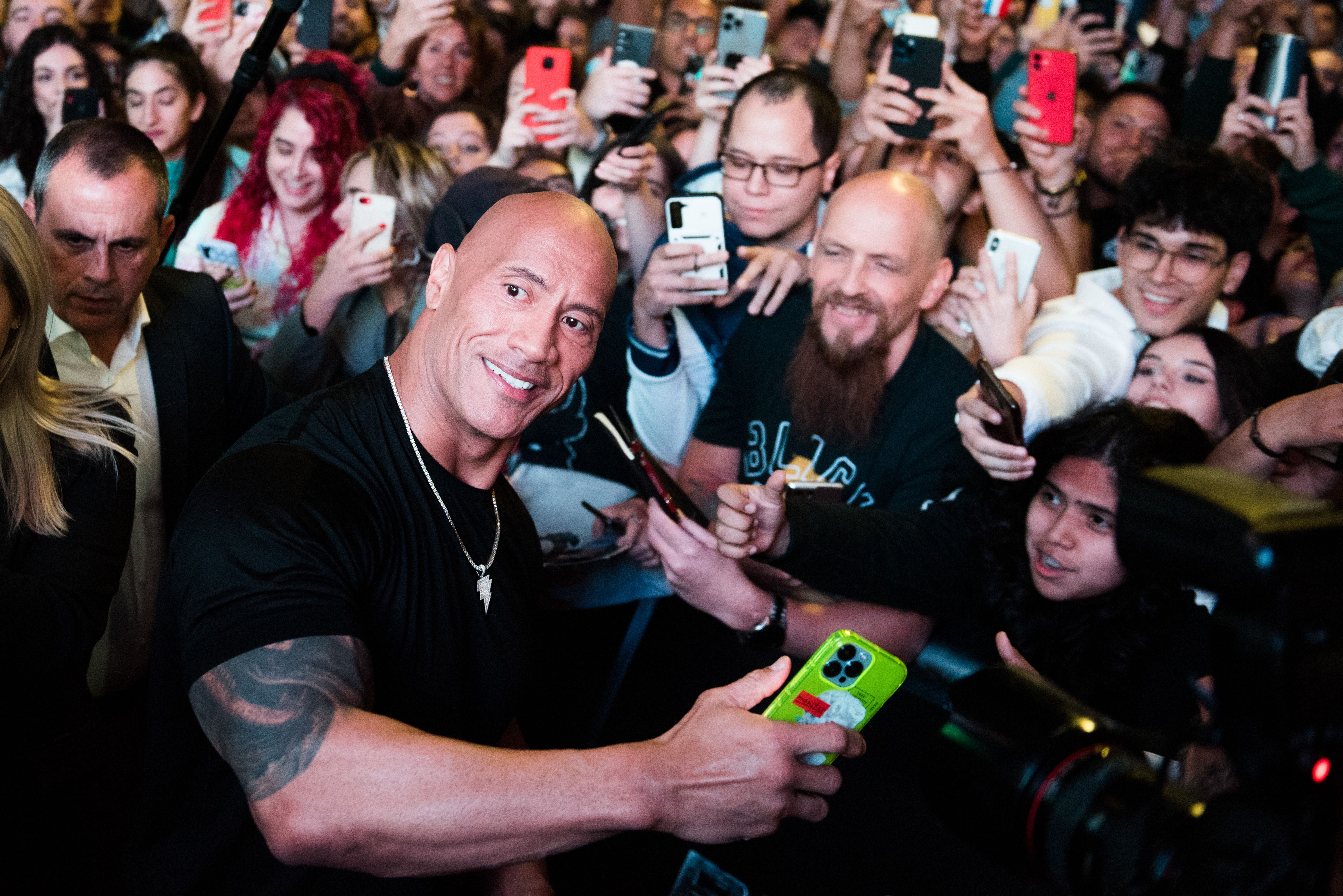 Actor Dwayne Johnson poses with fans at the Black Adam premiere
