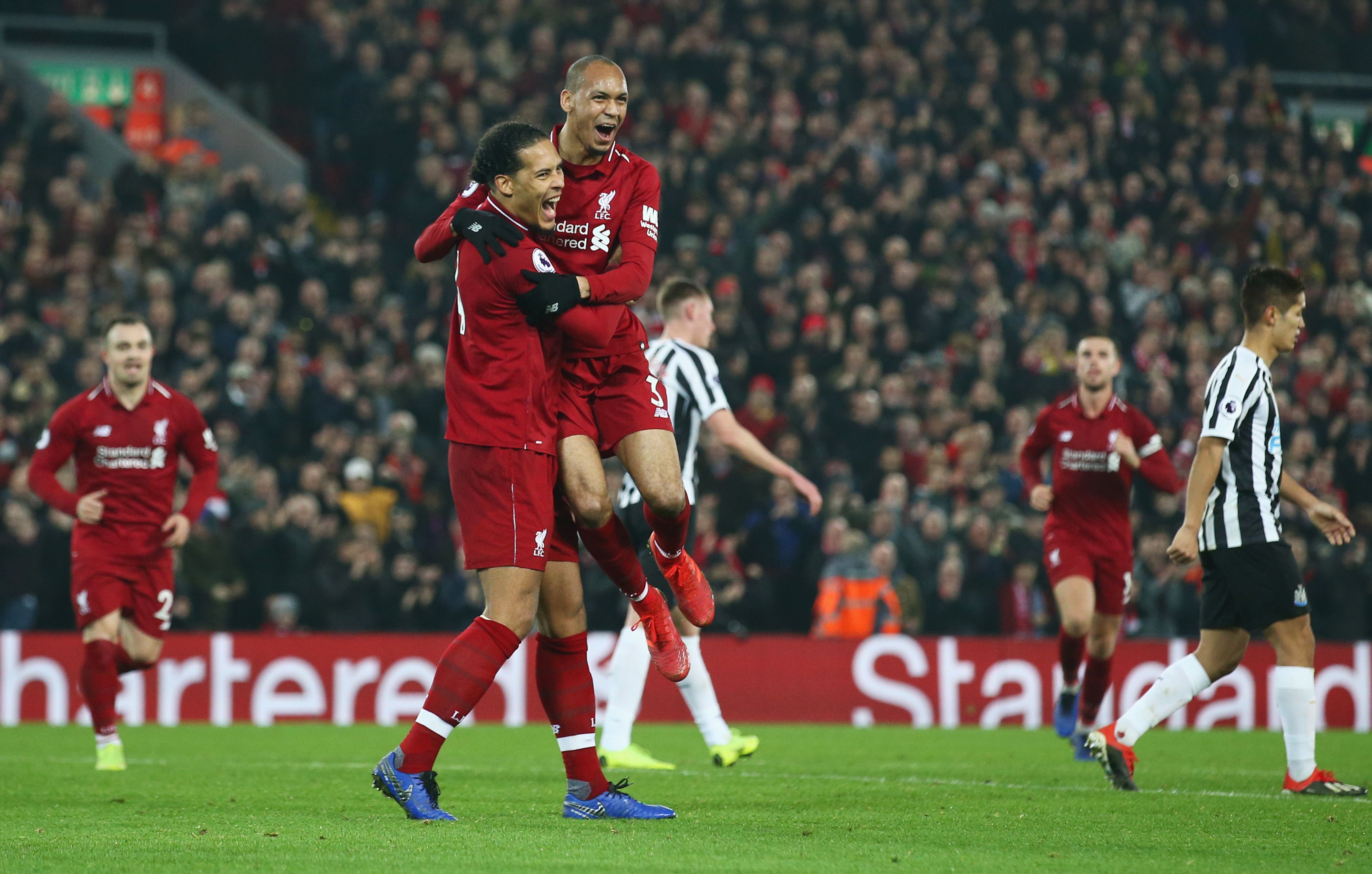 LIVERPOOL, ENGLAND - DECEMBER 26: Fabinho of Liverpool celebrates after scoring his team's fourth goal with team mate Virgil van Dijk during the Premier League match between Liverpool FC and Newcastle United at Anfield on December 26, 2018 in Liverpool, United Kingdom. (Photo by Jan Kruger/Getty Images)