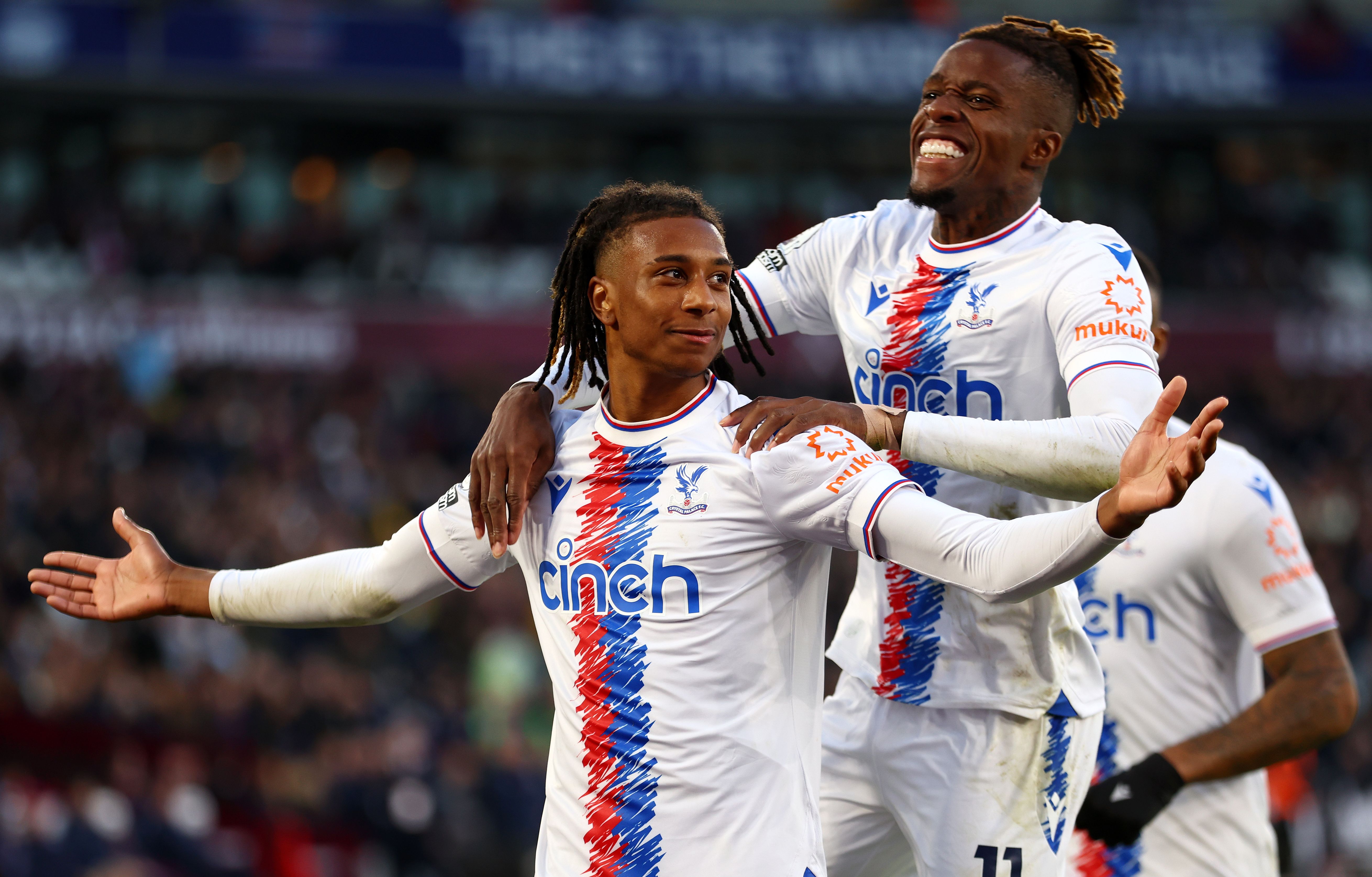 Michael Olise celebrates with Wilfried Zaha of Crystal Palace after scoring their team's second goal during the Premier League match between West Ham United and Crystal Palace at London Stadium on November 06, 2022 in London, 