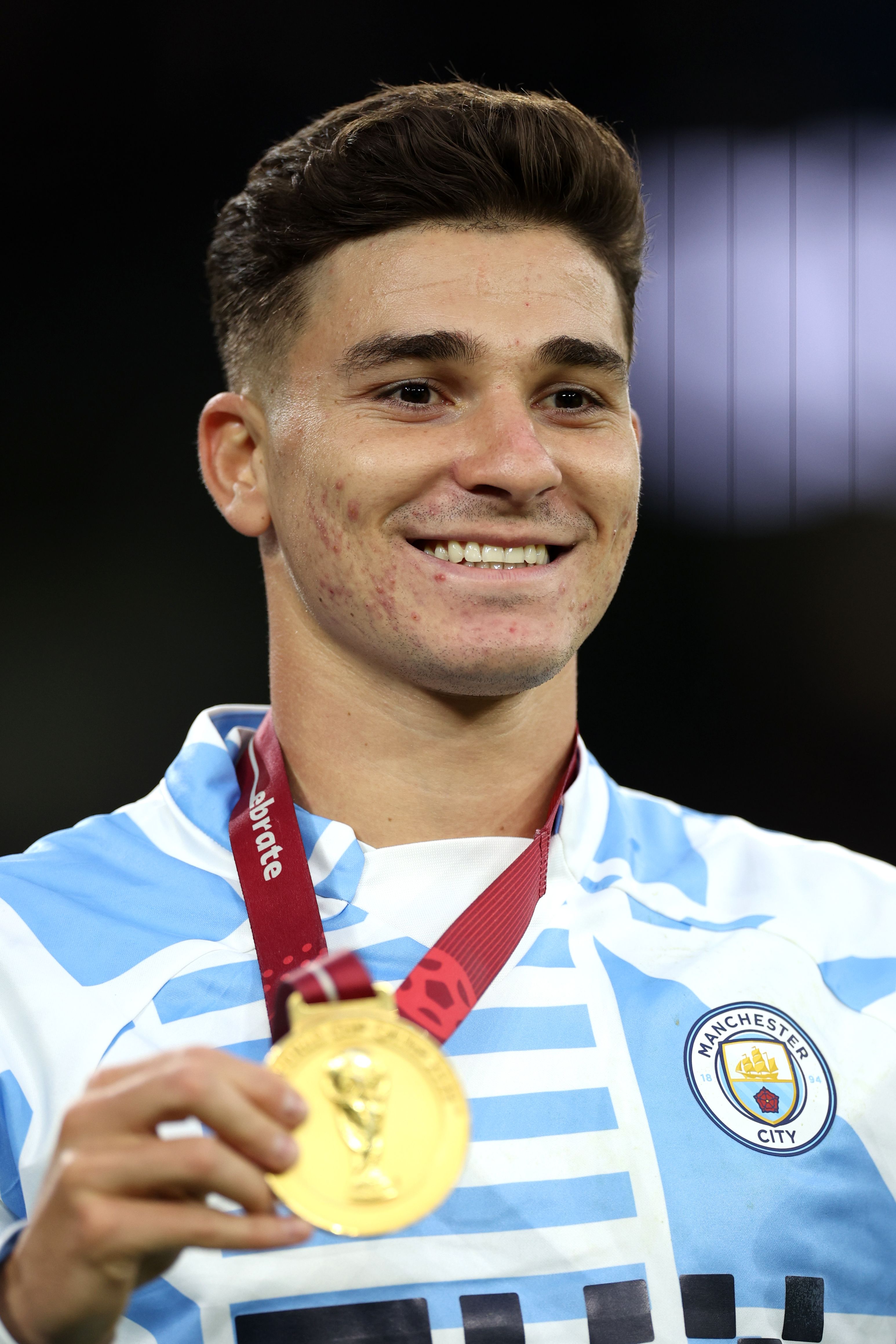 Alvarez holds up his World Cup medal.