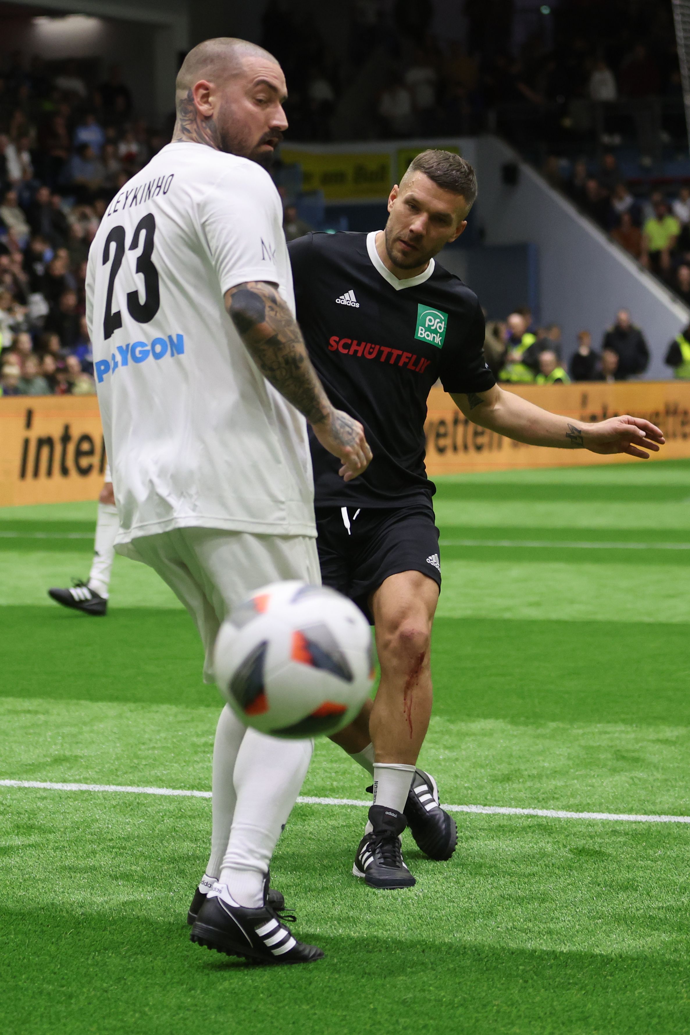 Podolski competing on an indoor pitch.