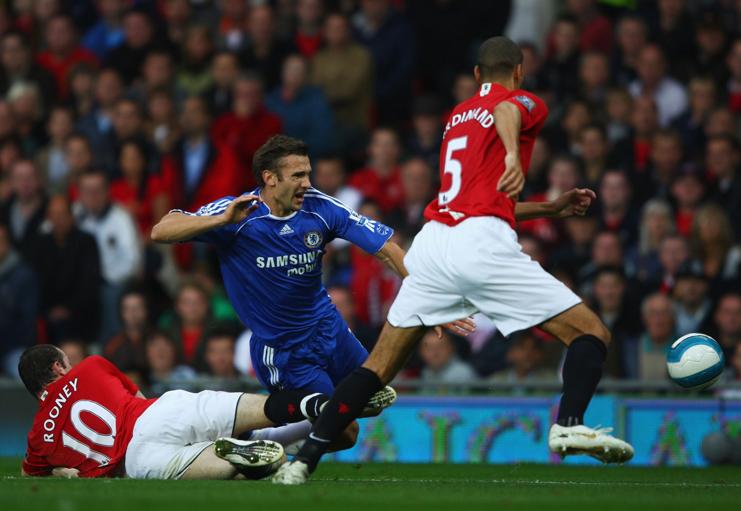 MANCHESTER, UNITED KINGDOM - SEPTEMBER 23: Andriy Shevchenko of Chelsea is tackled by Wayne Rooney of Manchester United as Rio Ferdiand look on during the Barclays Premier League match between Manchester United and Chelsea at Old Trafford on September 23, 2007 in Manchester, England. (Photo by Clive Brunskill/Getty Images)