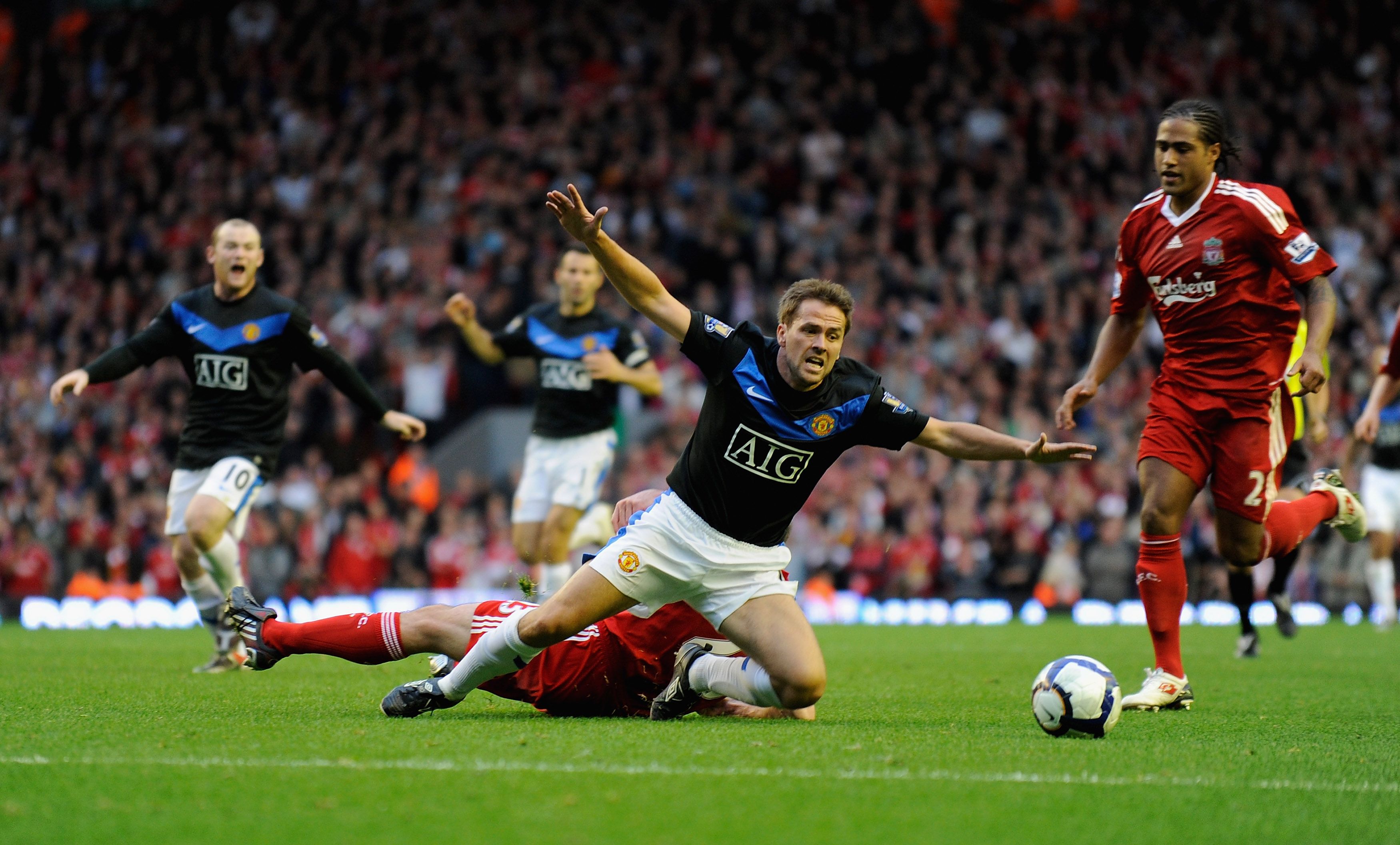 LIVERPOOL, ENGLAND - OCTOBER 25: Michael Owen of Manchester United is brought down by Jamie Carragher of Liverpool during the Barclays Premier League match between Liverpool and Manchester United at Anfield on October 25, 2009 in Liverpool, England. (Photo by Michael Regan/Getty Images)