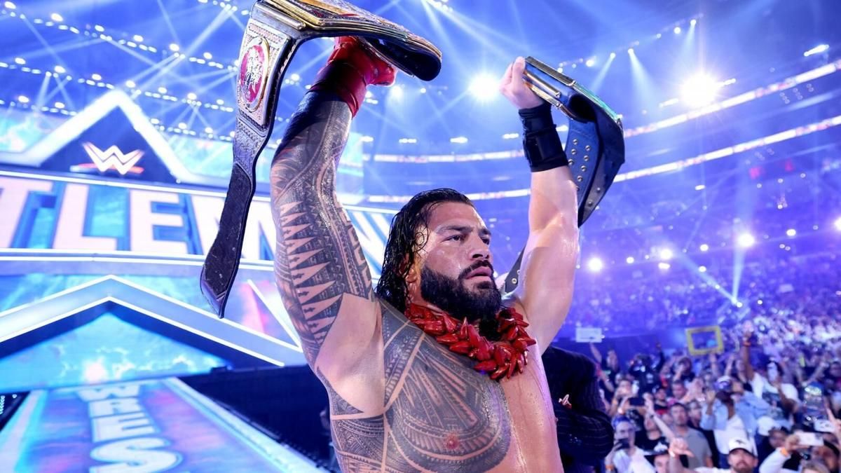 Roman Reigns holding WWE Championships