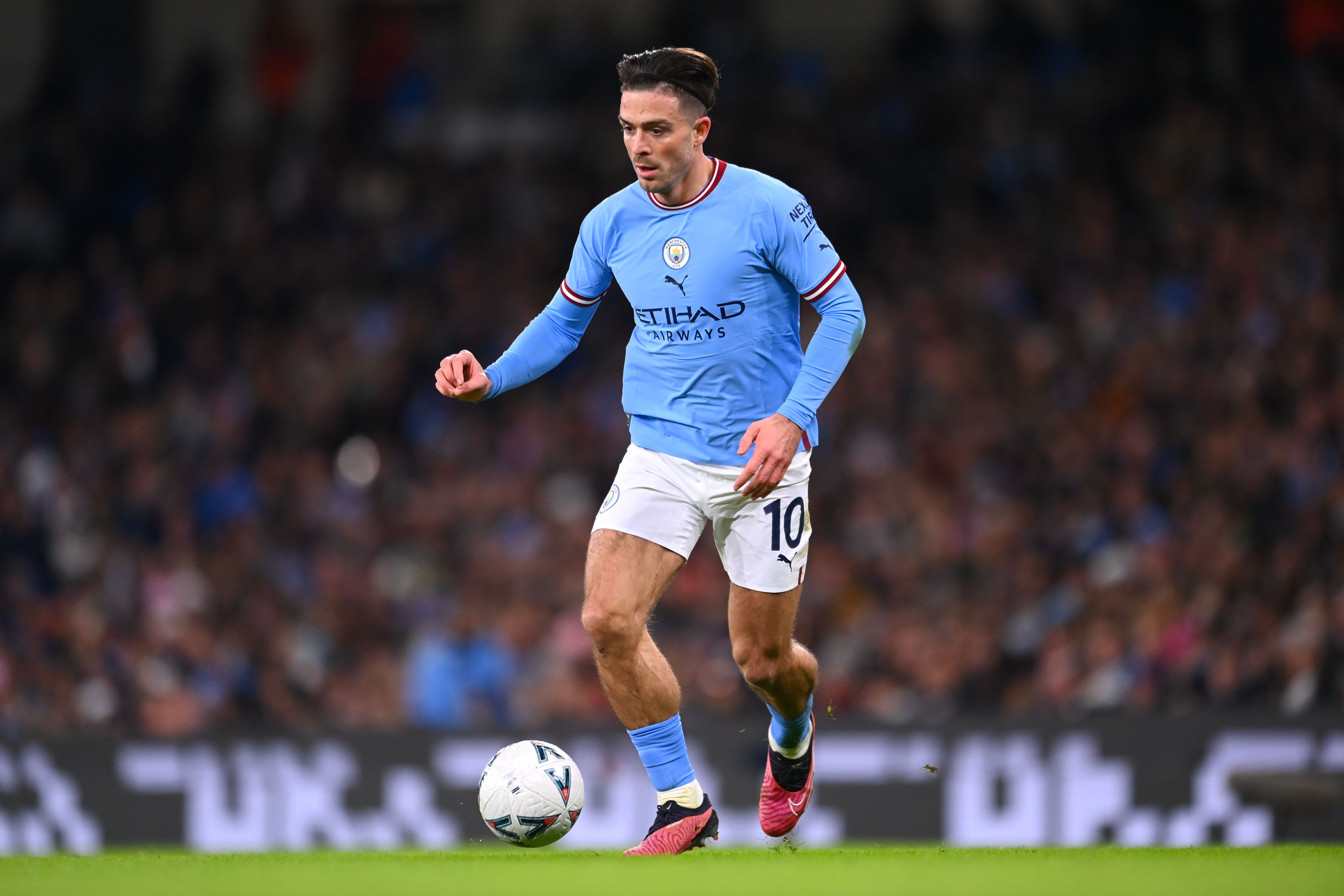 Jack Grealish of Manchester City in action during the Emirates FA Cup Fourth Round match at the Etihad Stadium on January 27, 2023 in Manchester, England