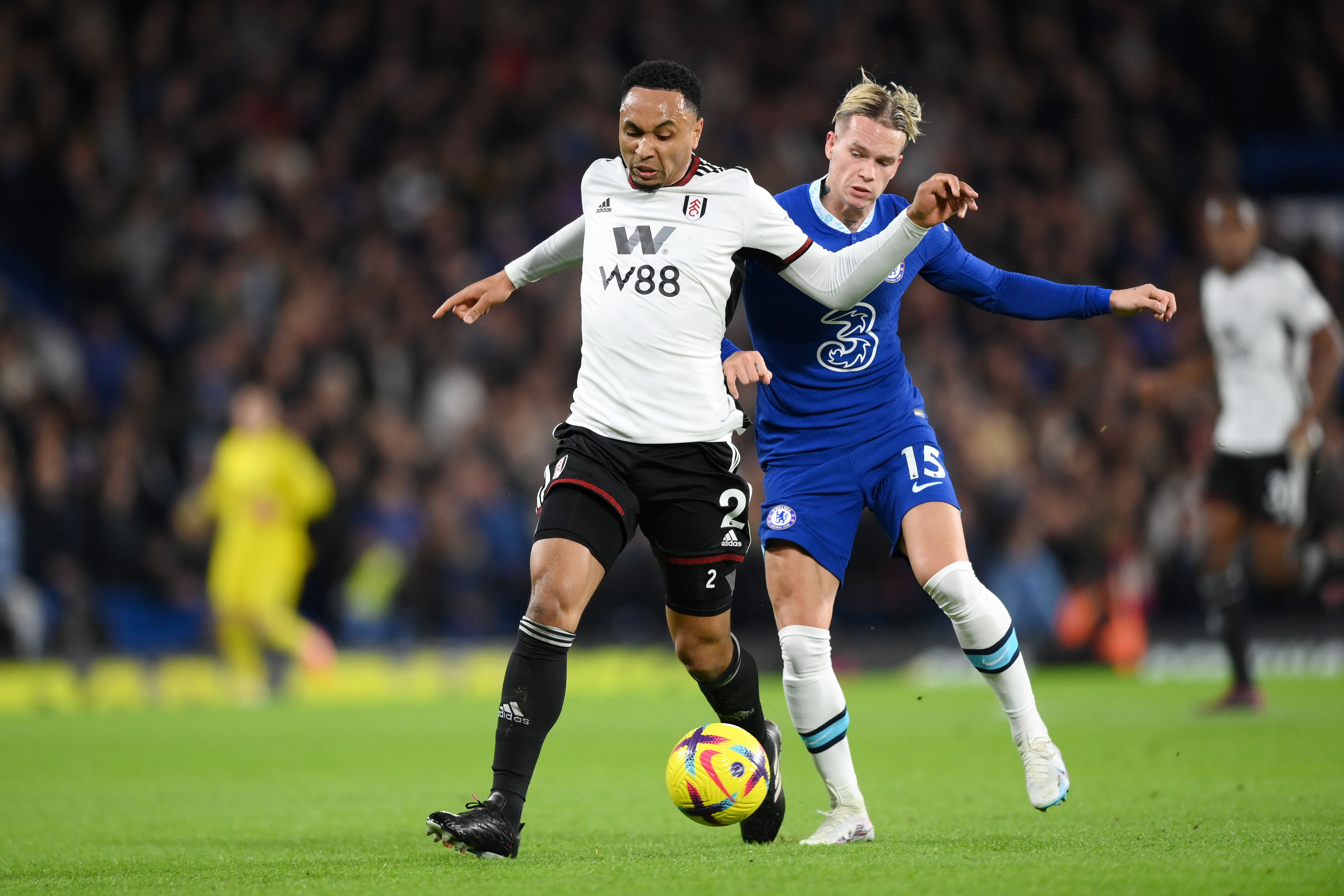 Mykhailo Mudryk of Chelsea challenges for the ball with Kenny Tete