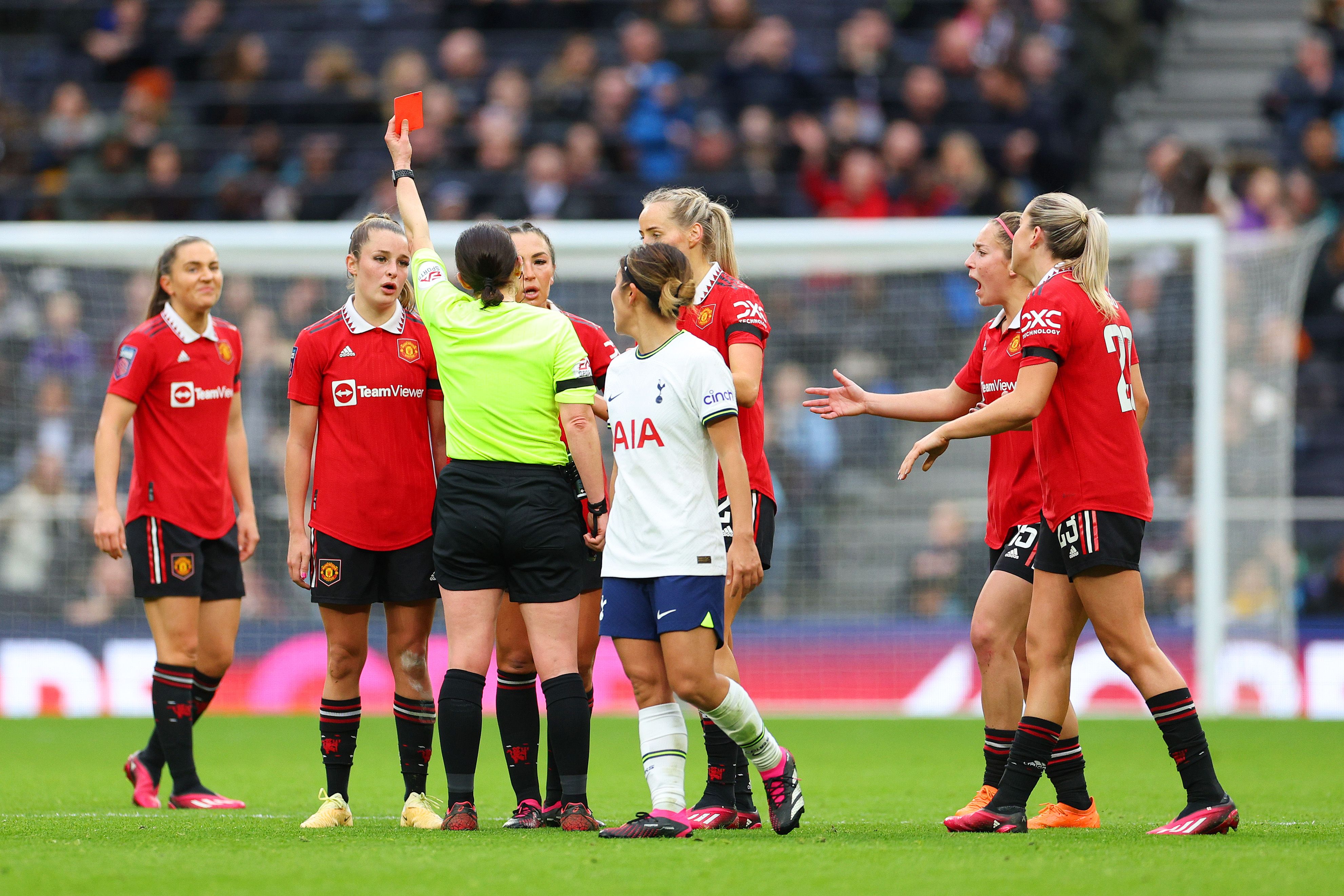 Ella Toone of Man United is shown a red card