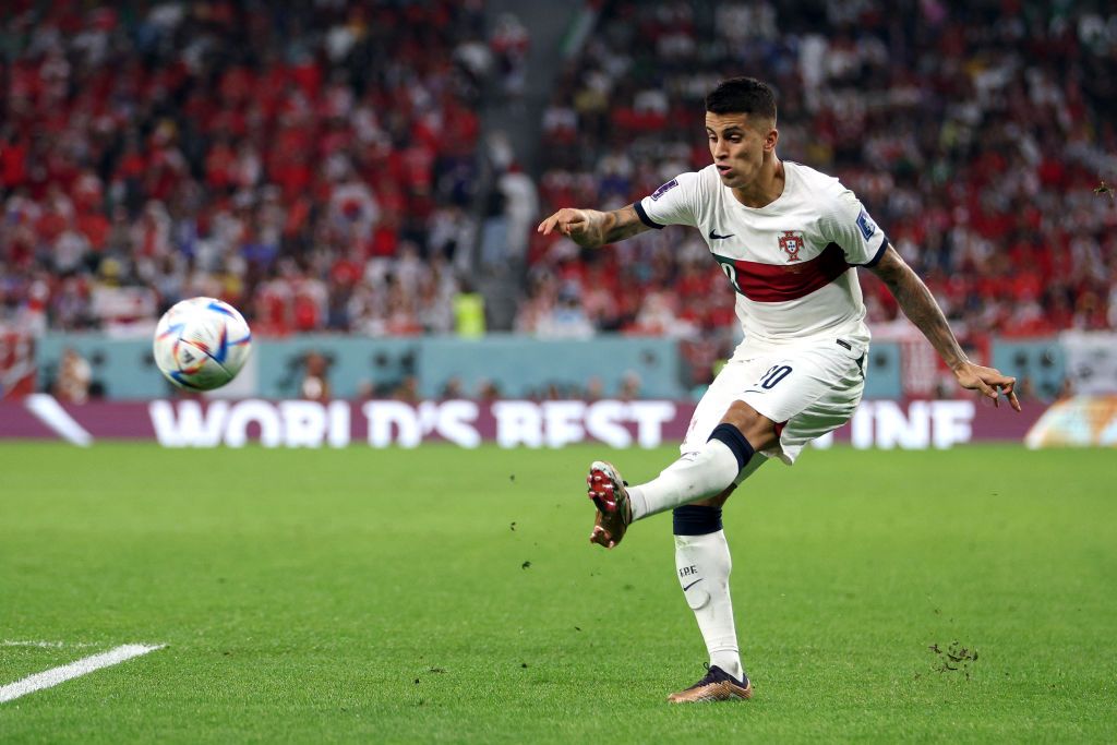 Joao Cancelo crosses the ball for Portugal