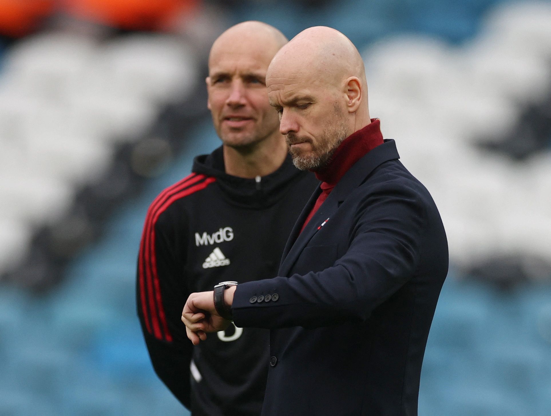 Manchester United manager Erik ten Hag checking the time