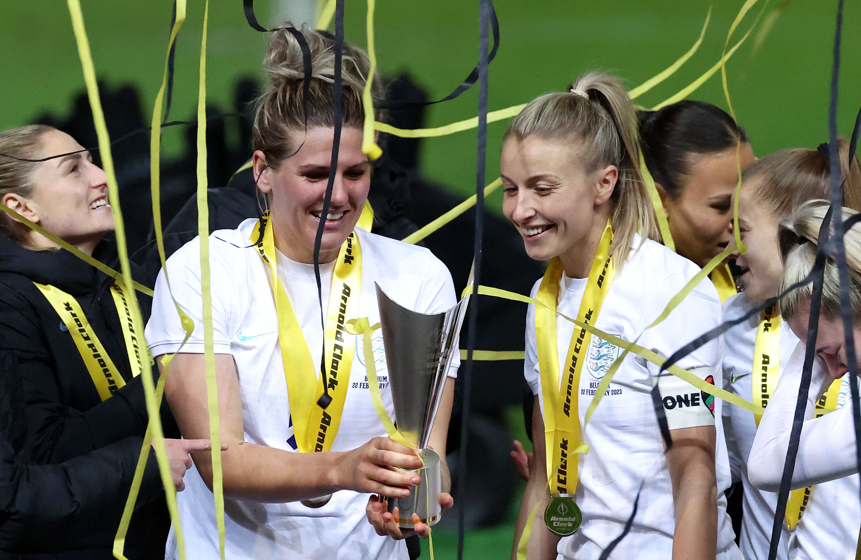 Millie Bright and Leah Williamson celebrate with the Arnold Clark Cup 
