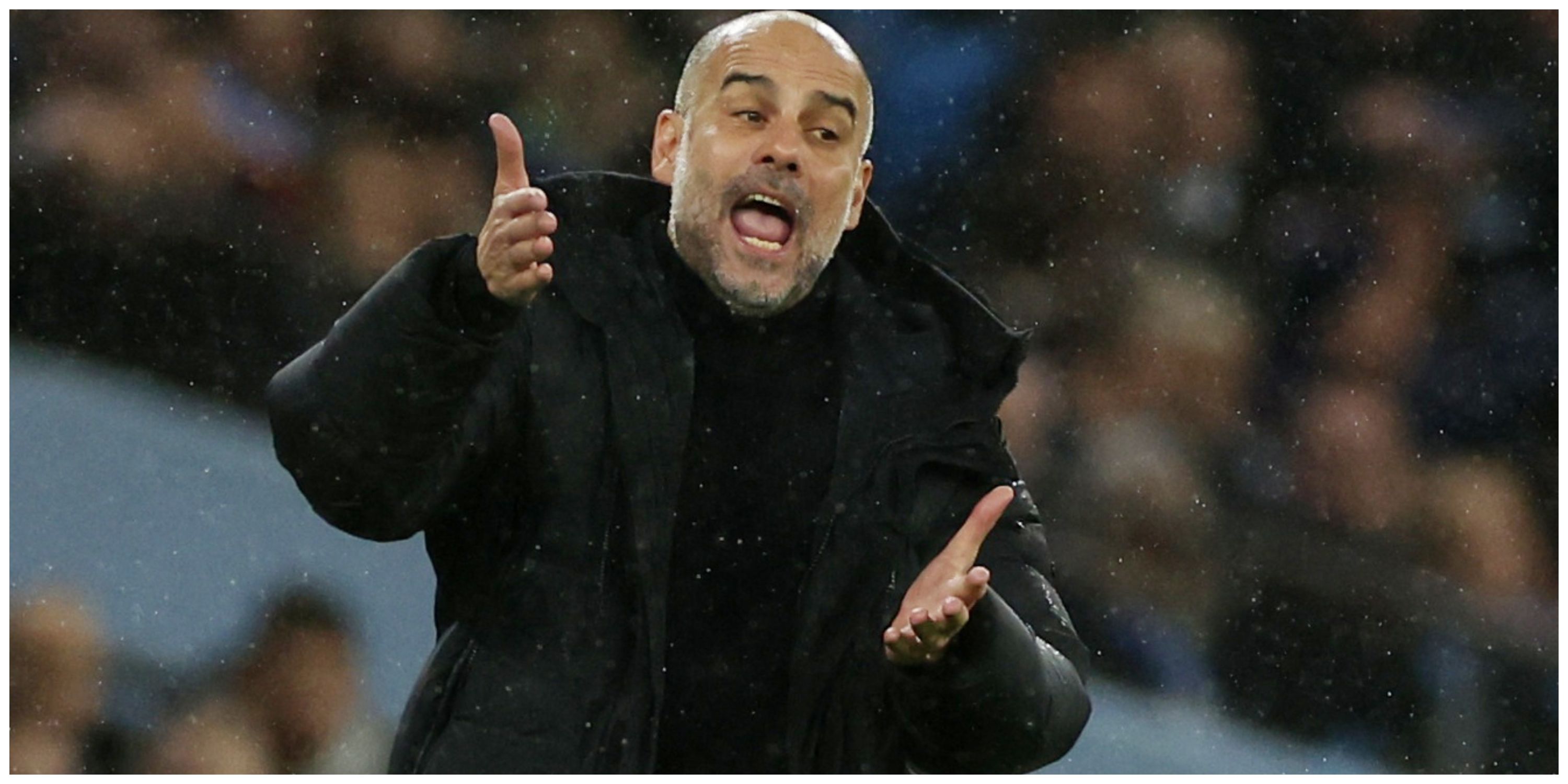 Manchester City manager Pep Guardiola standing in the rain