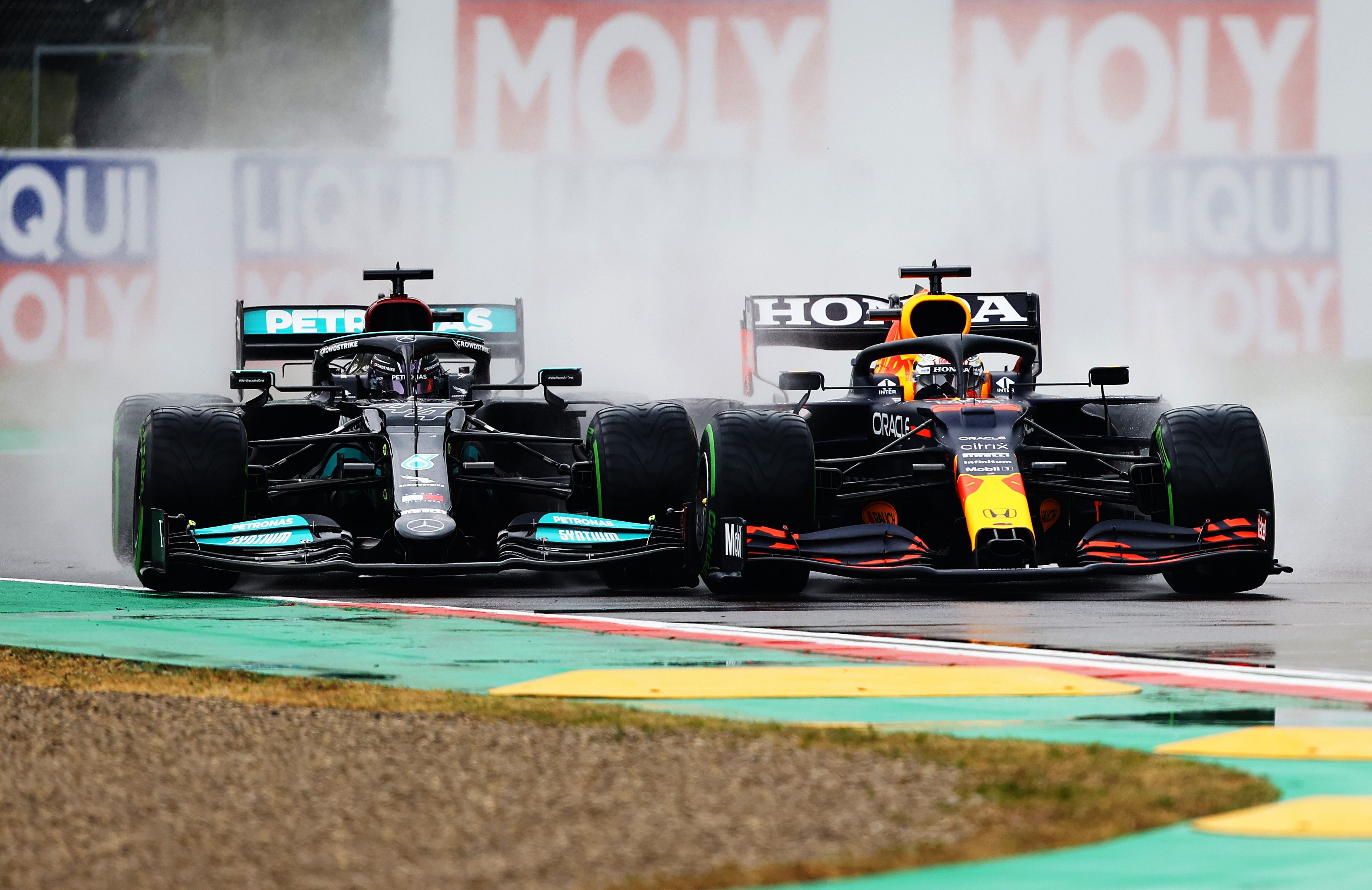 Lewis Hamilton of Great Britain with the (44) Mercedes AMG Petronas F1 Team Mercedes W12 and Max Verstappen of the Netherlands with the (33) Red Bull Racing RB16B Honda battle it out during the Emilia Romagna F1 Grand Prix at the Autodromo Enzo e Dino Ferrari April 18 2021 in Imola, Italy.