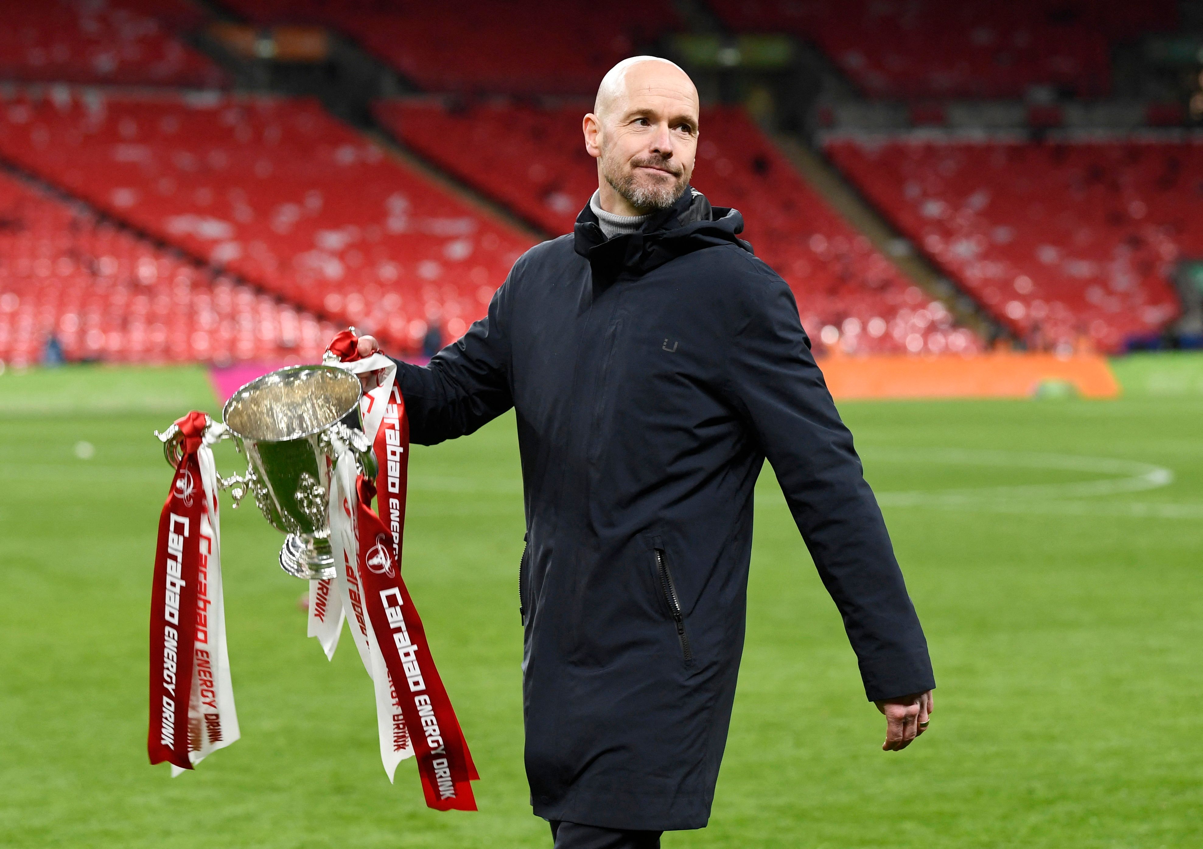 Manchester United manager Erik ten Hag carrying Carabao Cup
