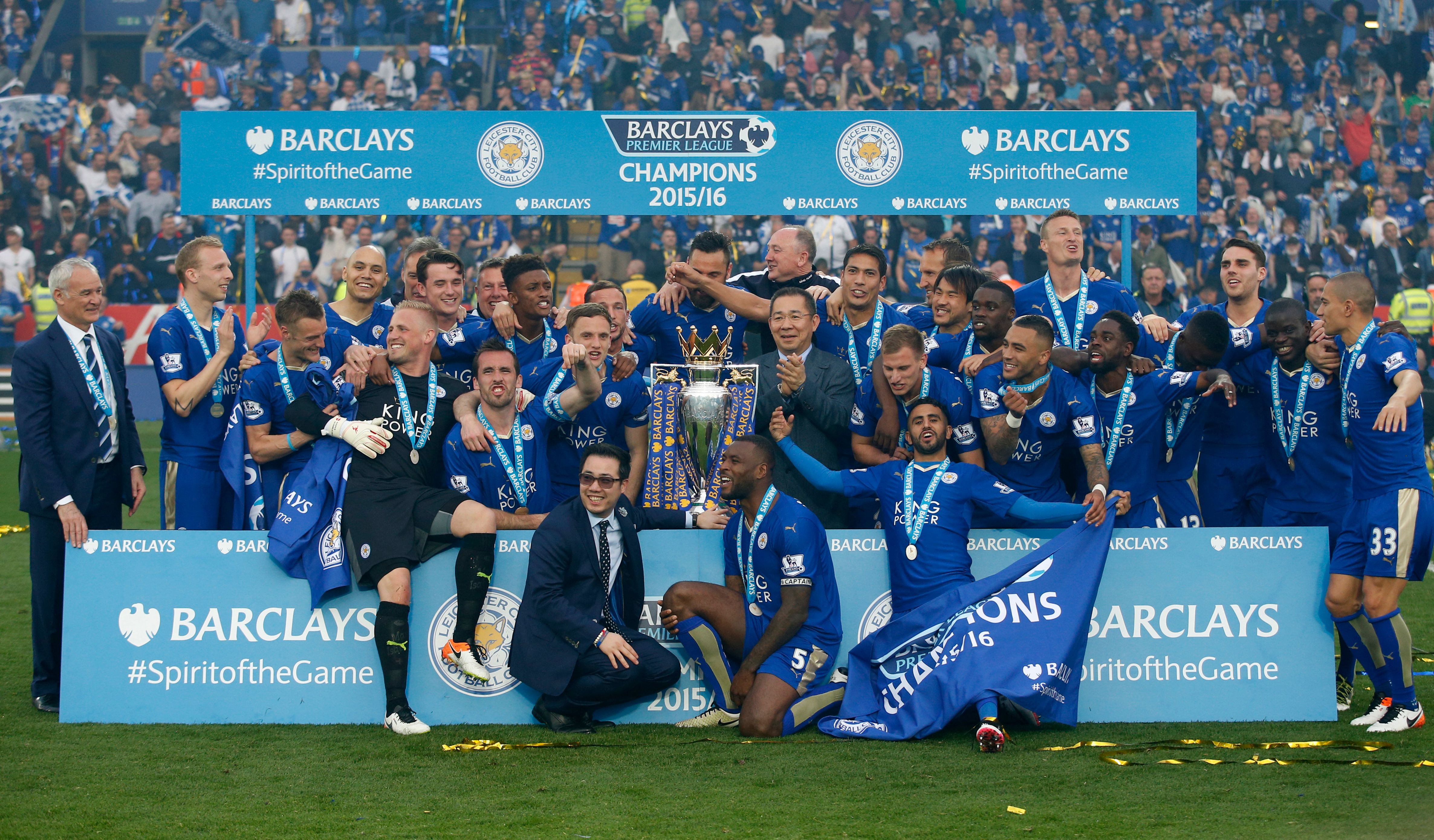 Leicester City players celebrate with the Premier League trophy.