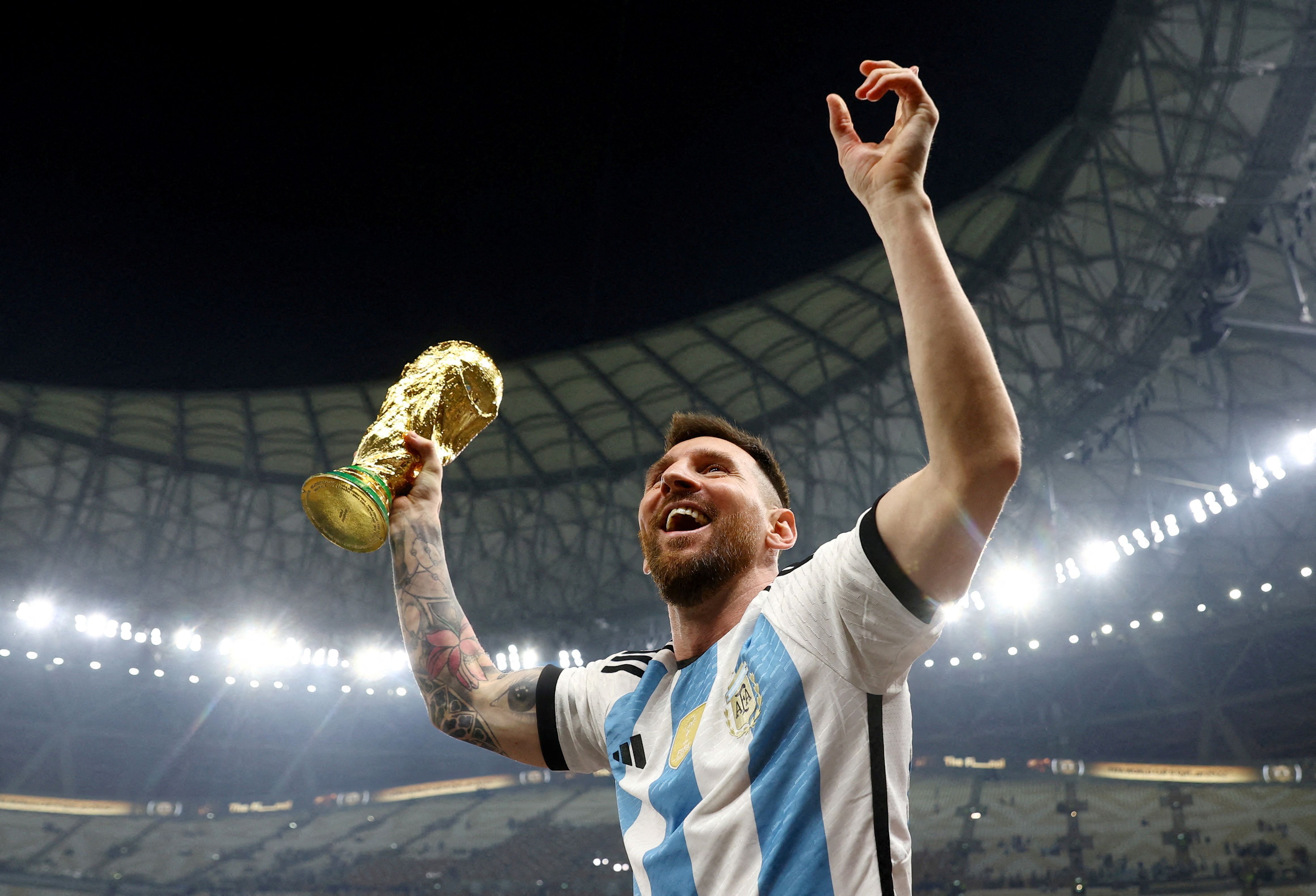 Lionel Messi with the World Cup trophy