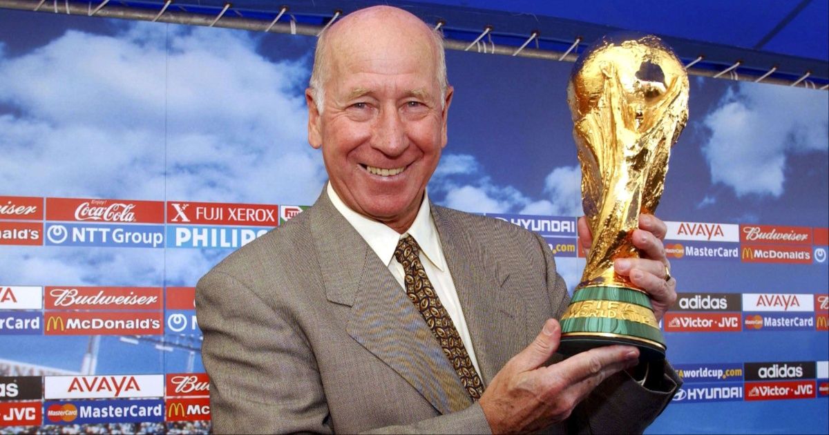 Bobby Charlton holding the World Cup in 2002