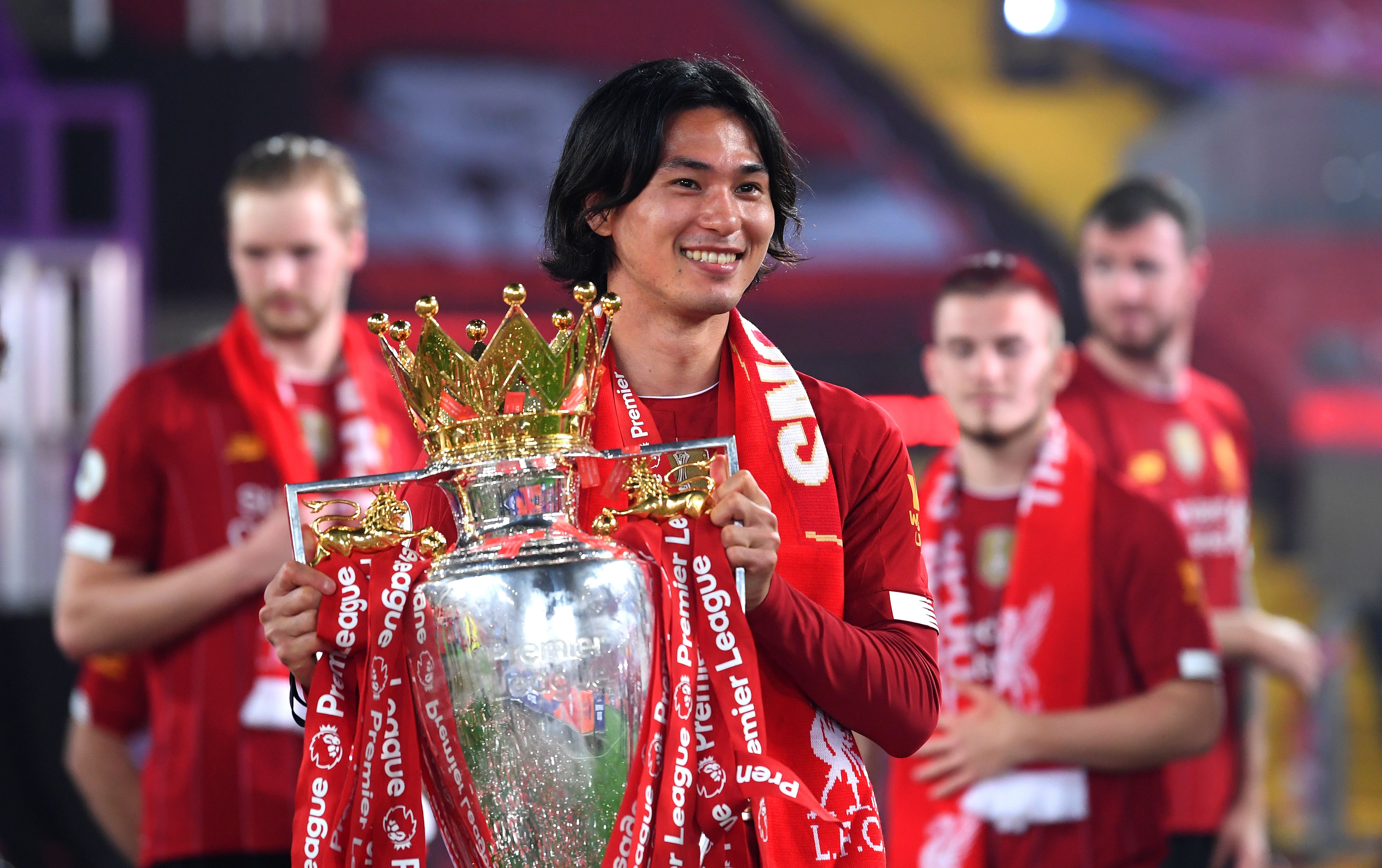 Takumi Minamino lifts the Premier League trophy as a Liverpool player