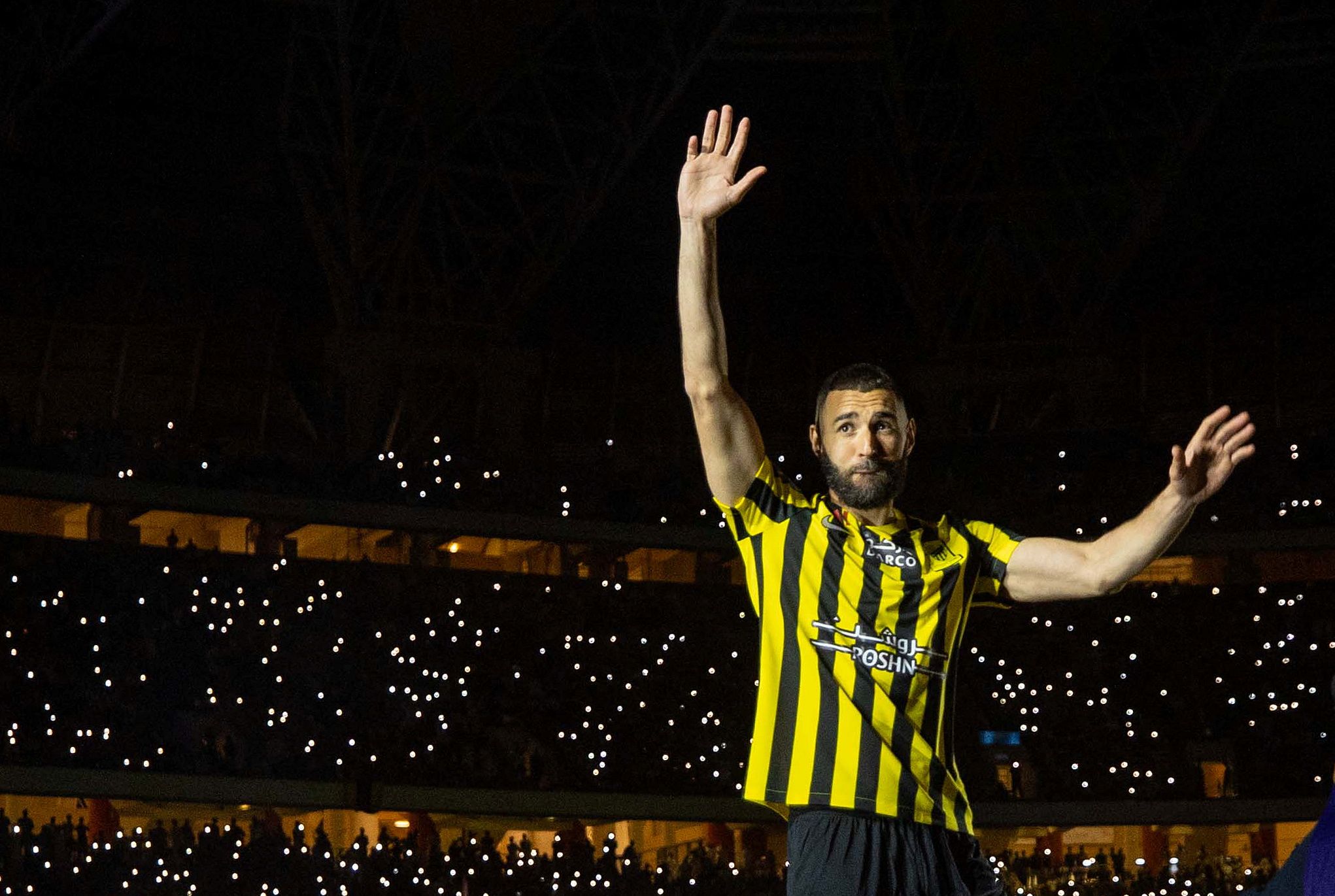 Karim Benzema waves to a packed out crowd during his presentation ceremony at Al-Ittihad after joining the club