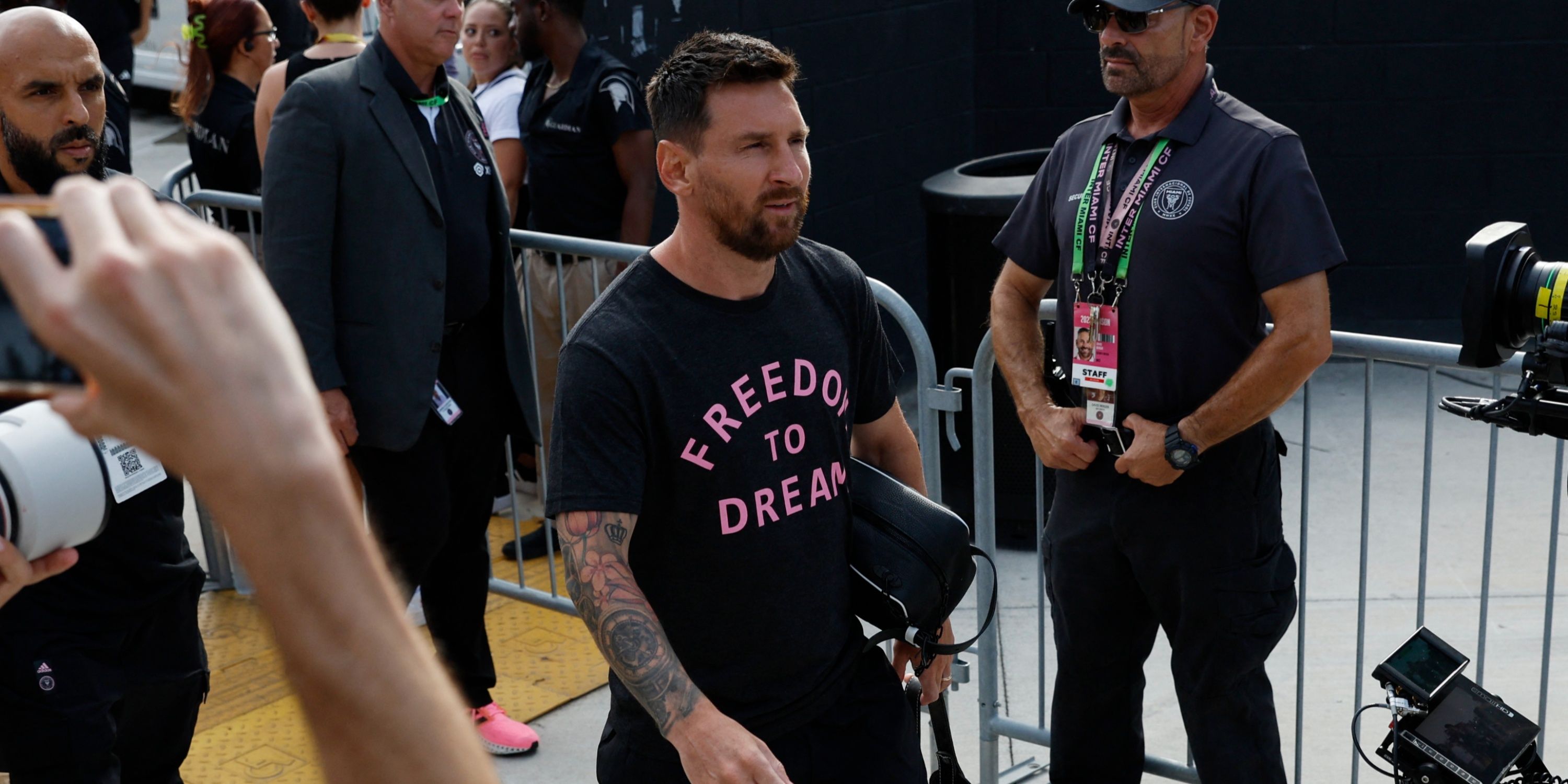 Lionel Messi and his bodyguard (left)