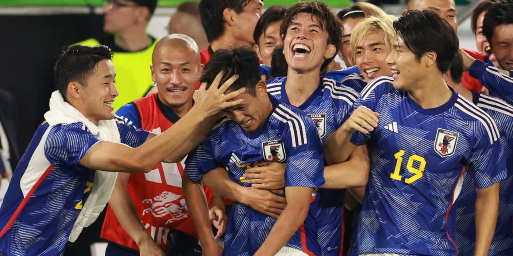 Japan players celebrate v Germany
