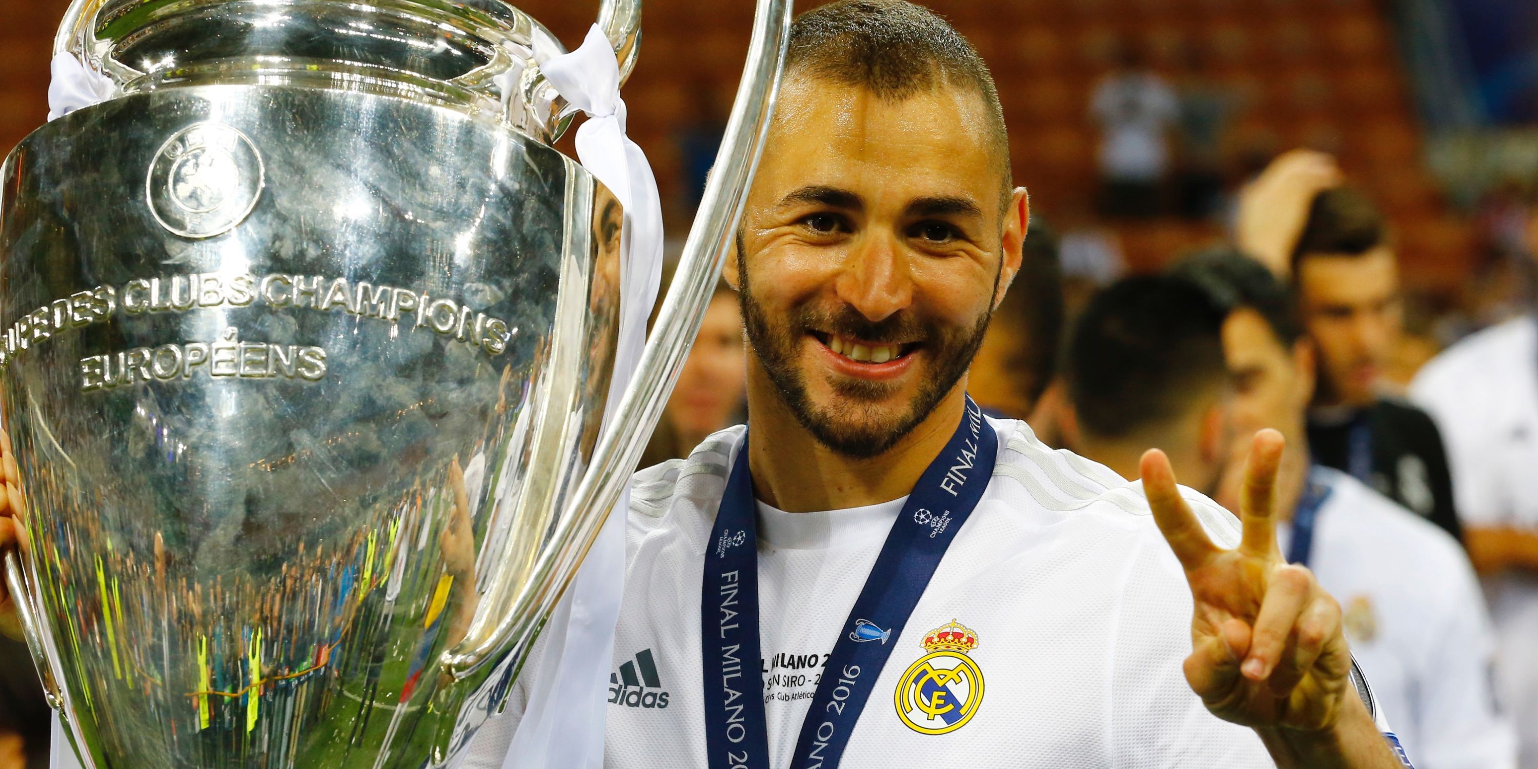 Karim Benzema holding the Champions League trophy.