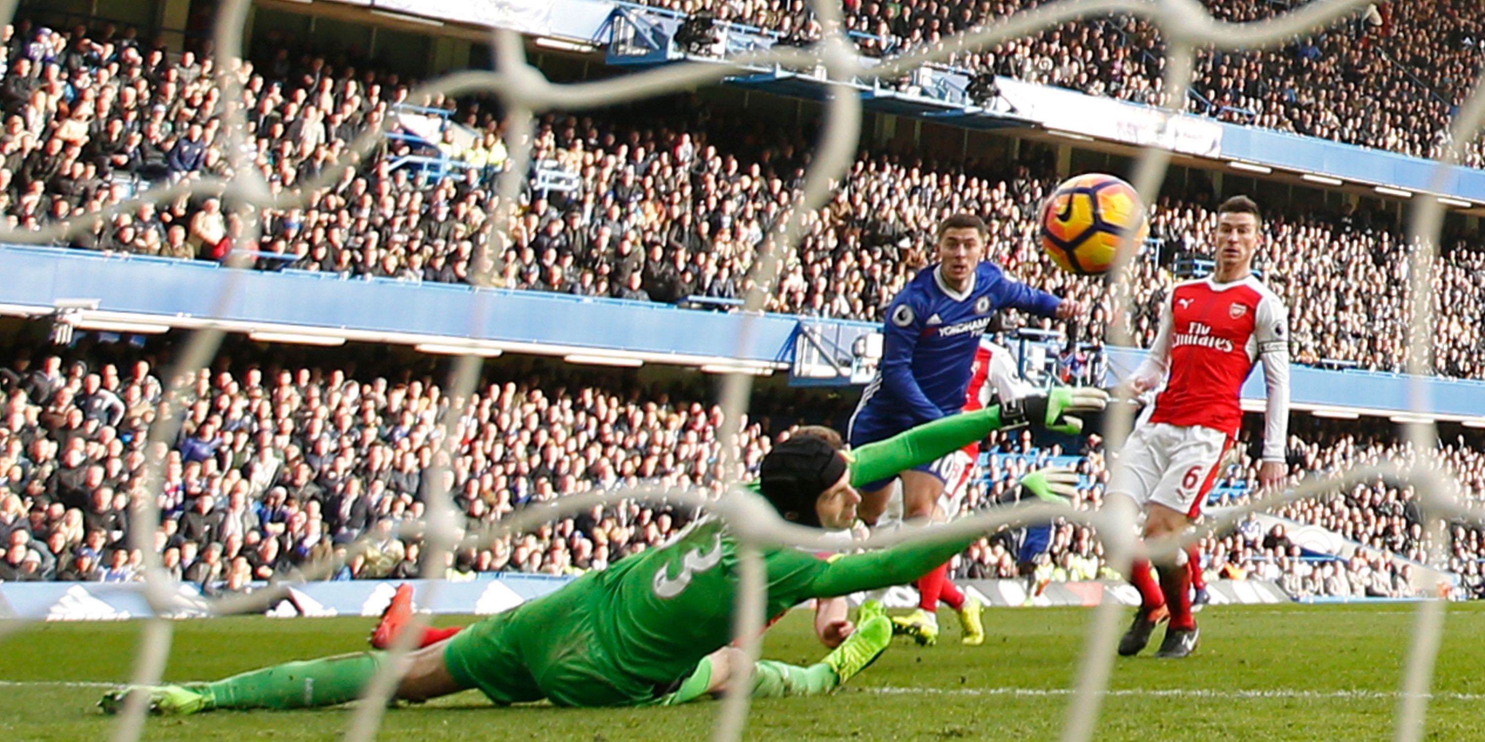 Chelsea's Eden Hazard lifts the ball over Arsenal's Petr Cech.
