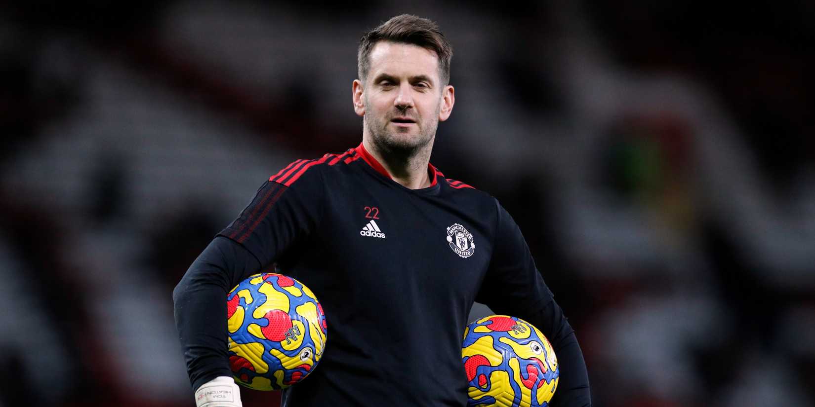 Manchester United goalkeeper Tom Heaton looks on