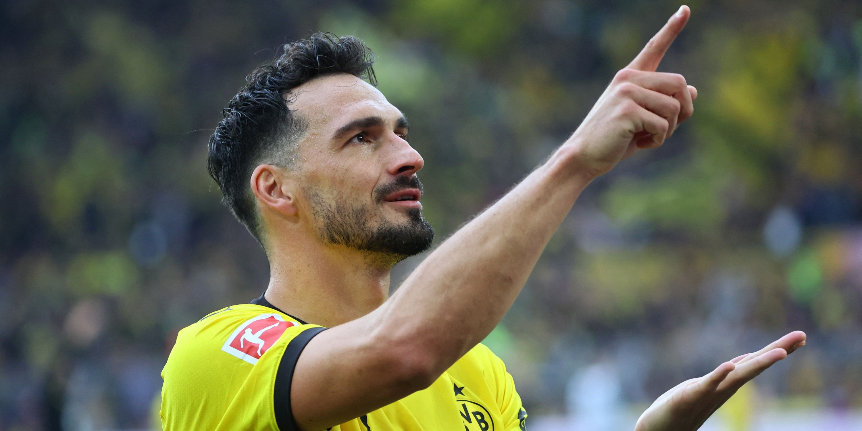 Borussia Dortmund's Mats Hummels points to supporters.