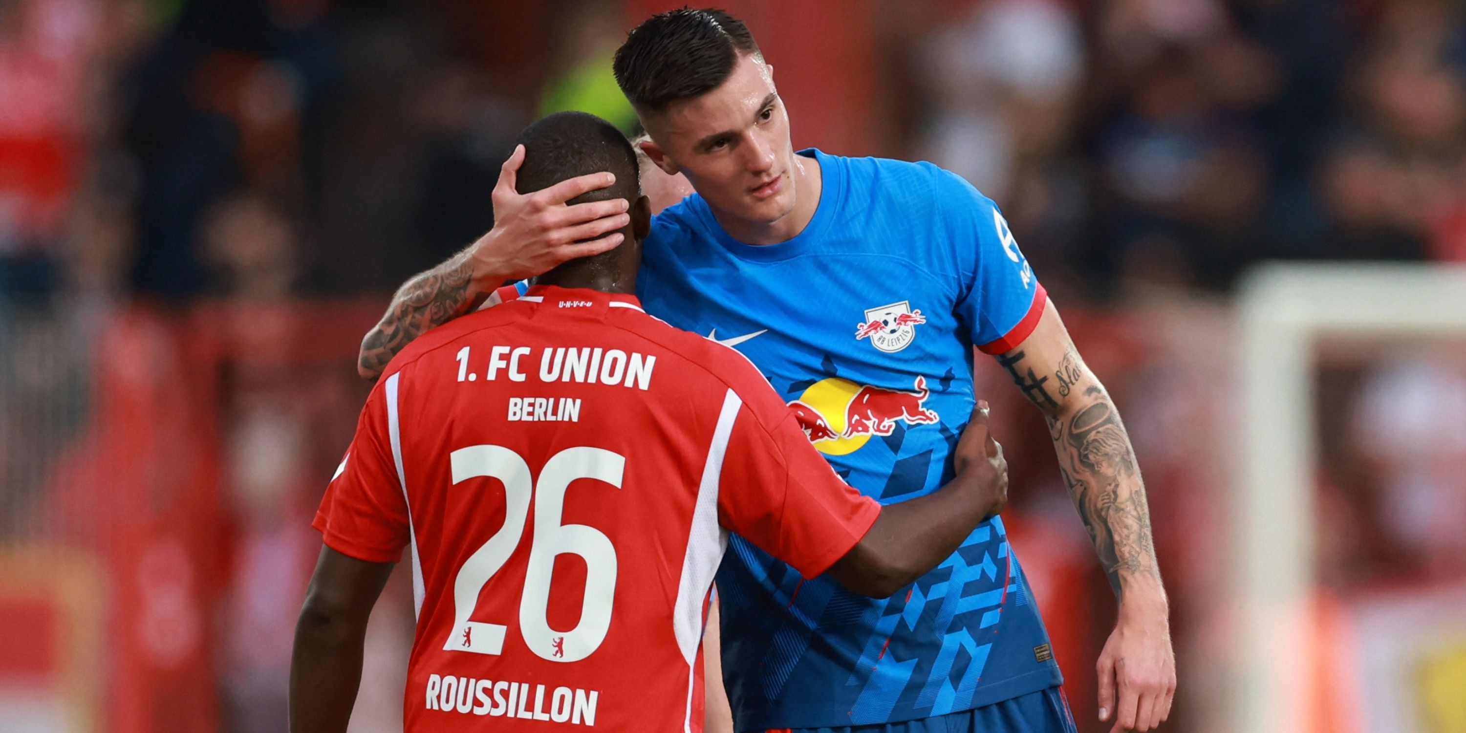 RB Leipzig striker Benjamin Sesko embraces opponent