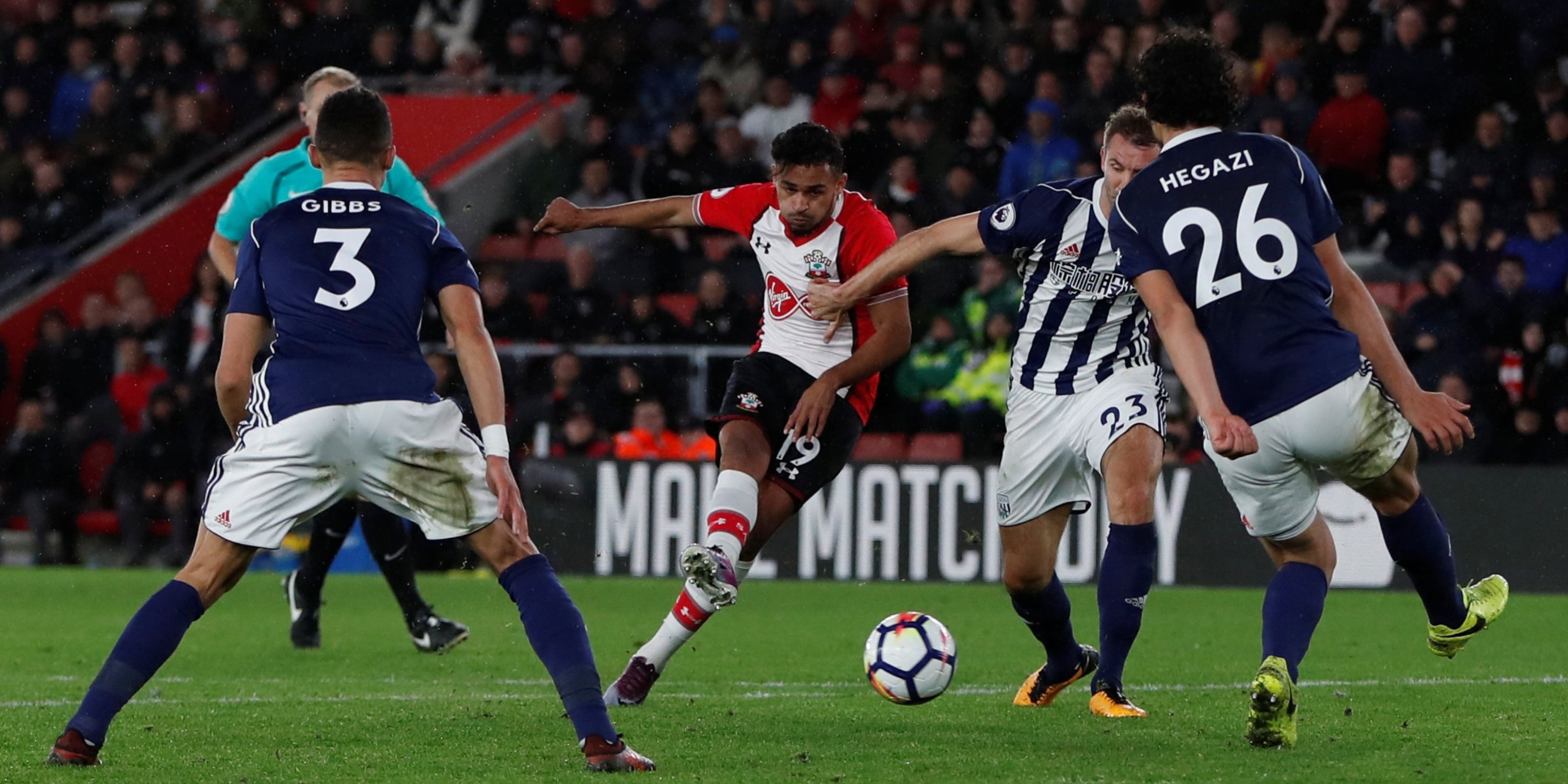 Southampton's Sofiane Boufal gets the shot away through a forest of West Brom players.