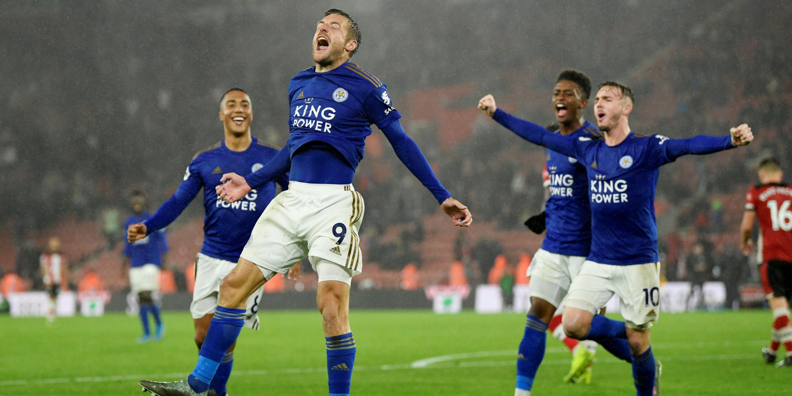 Leicester City's Jamie Vardy jumps in the air in celebration, flanked by teammates Youri Tielemans, Demarai Gray and James Maddison.