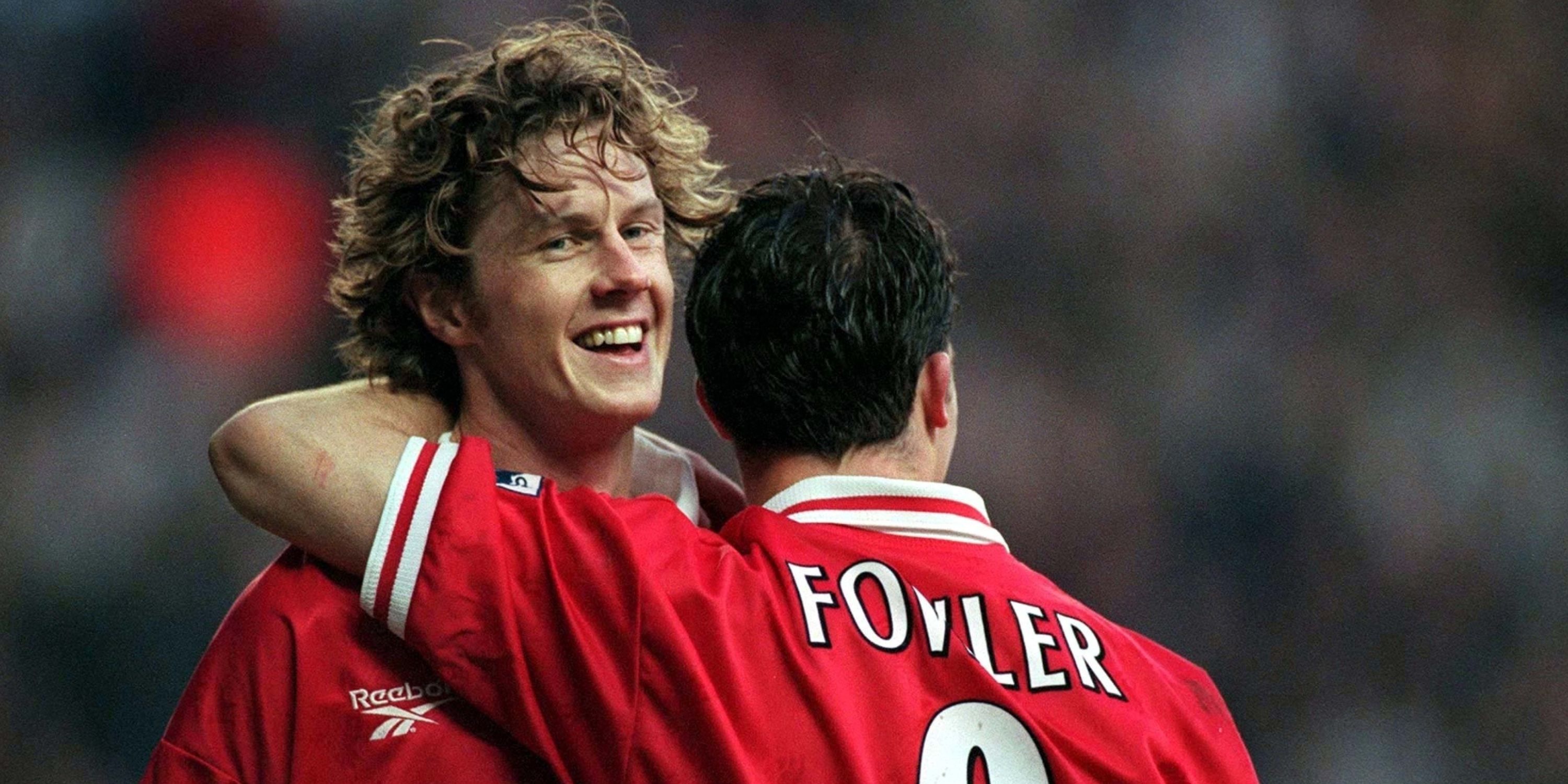 Liverpool pair Steve McManaman and Robbie Fowler share an embrace. 