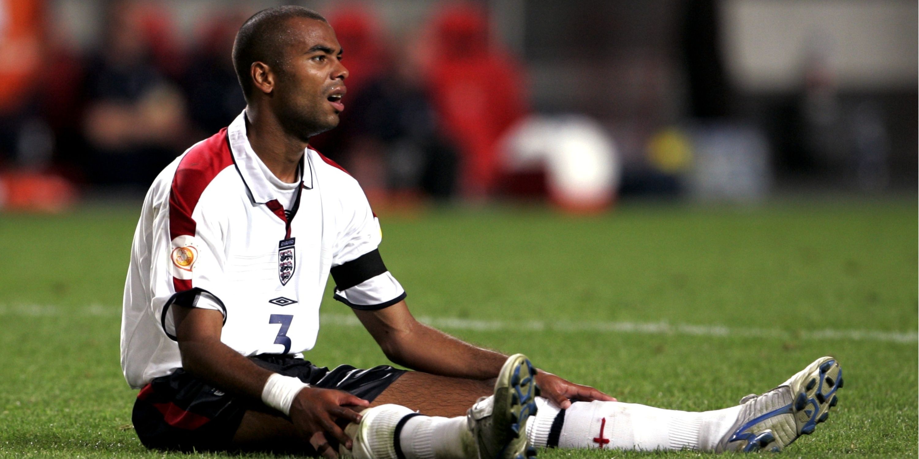 Ashley Cole playing for England. Sitting on the floor