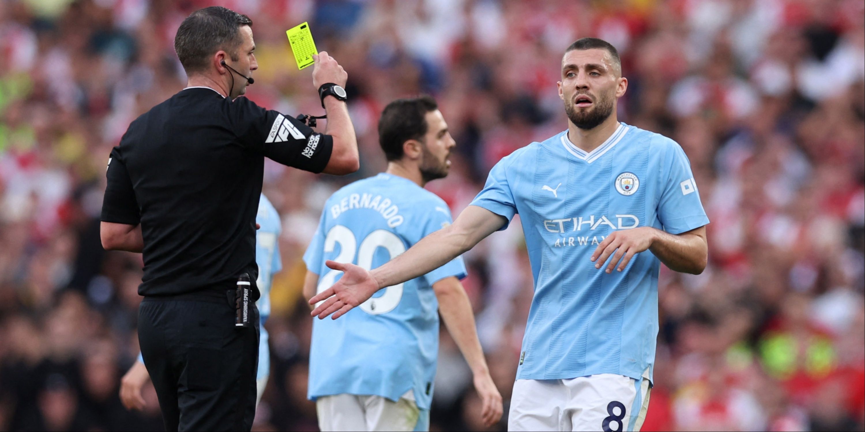 Manchester City's Mateo Kovacic is shown a yellow card