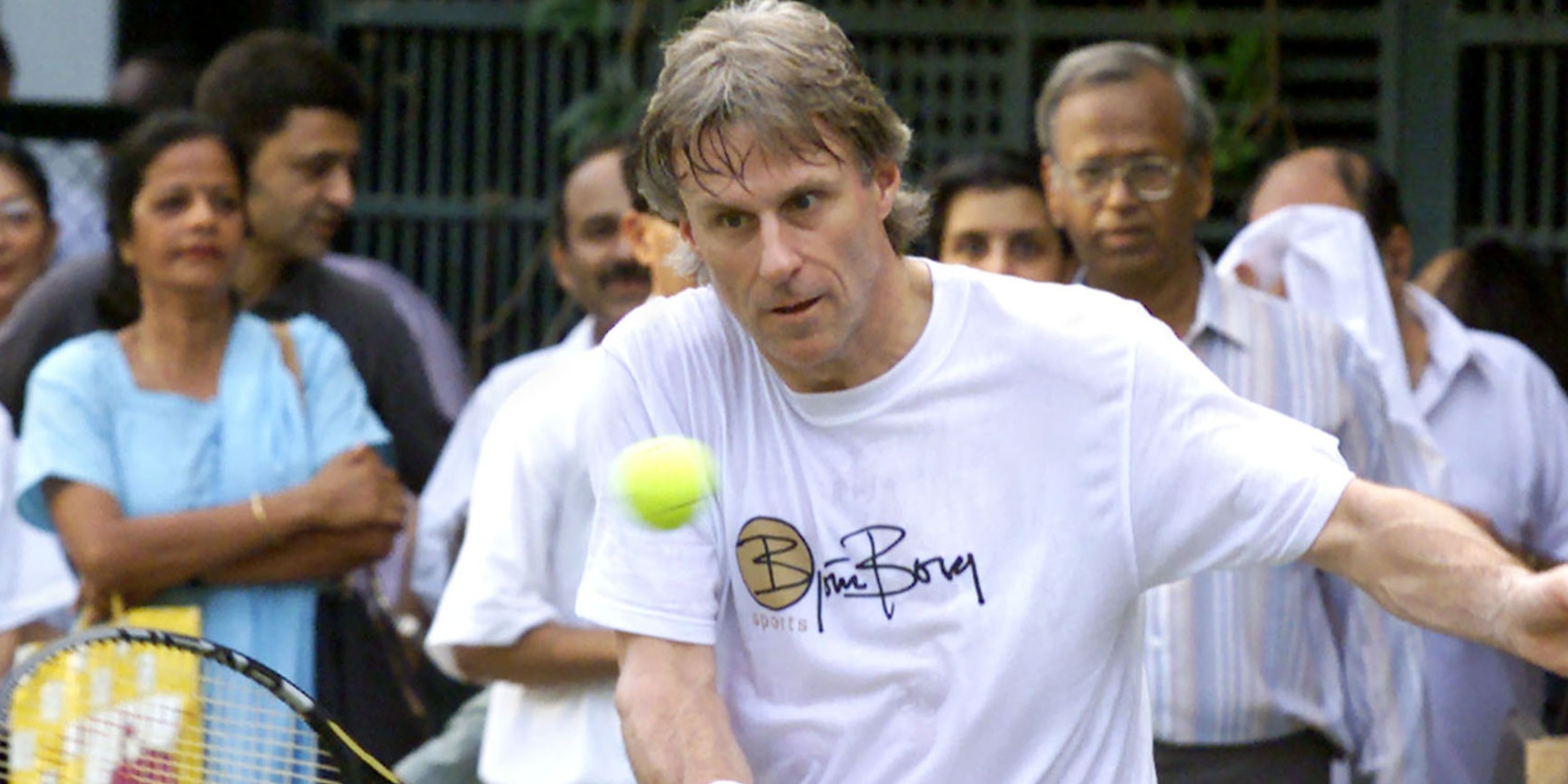 Tennis enthusiasts watch Bjorn Borg play a shot in Bombay.