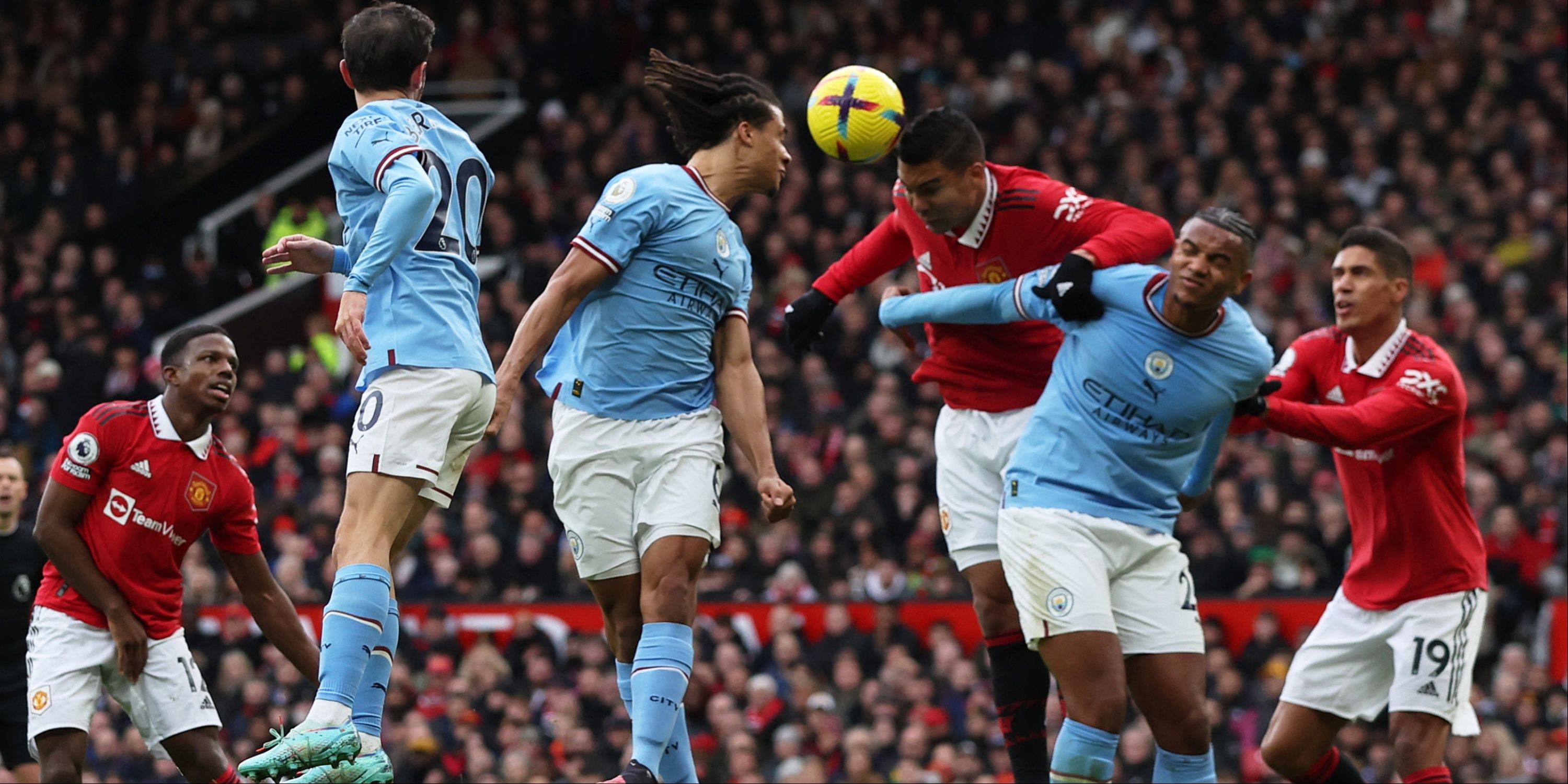 Manchester United's Casemiro in action with Manchester City's Nathan Ake and Manuel Akanji