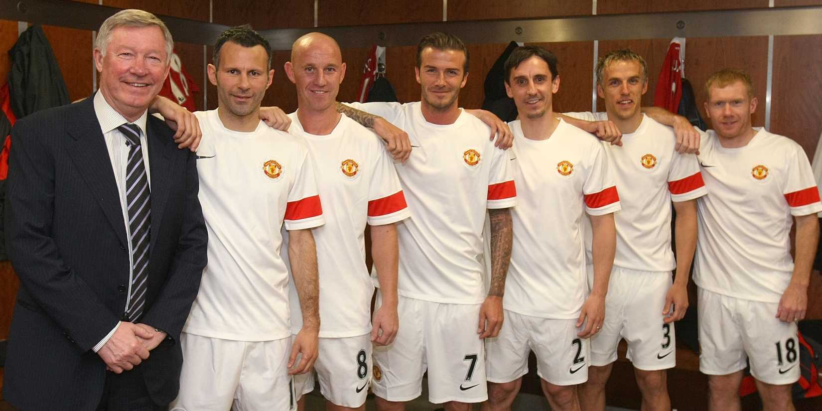 Sir Alex Ferguson, Ryan Giggs, Nicky Butt, David Beckham, Gary Neville, Phil Neville and Paul Scholes of Manchester United recreate the famous Class of '92 photo