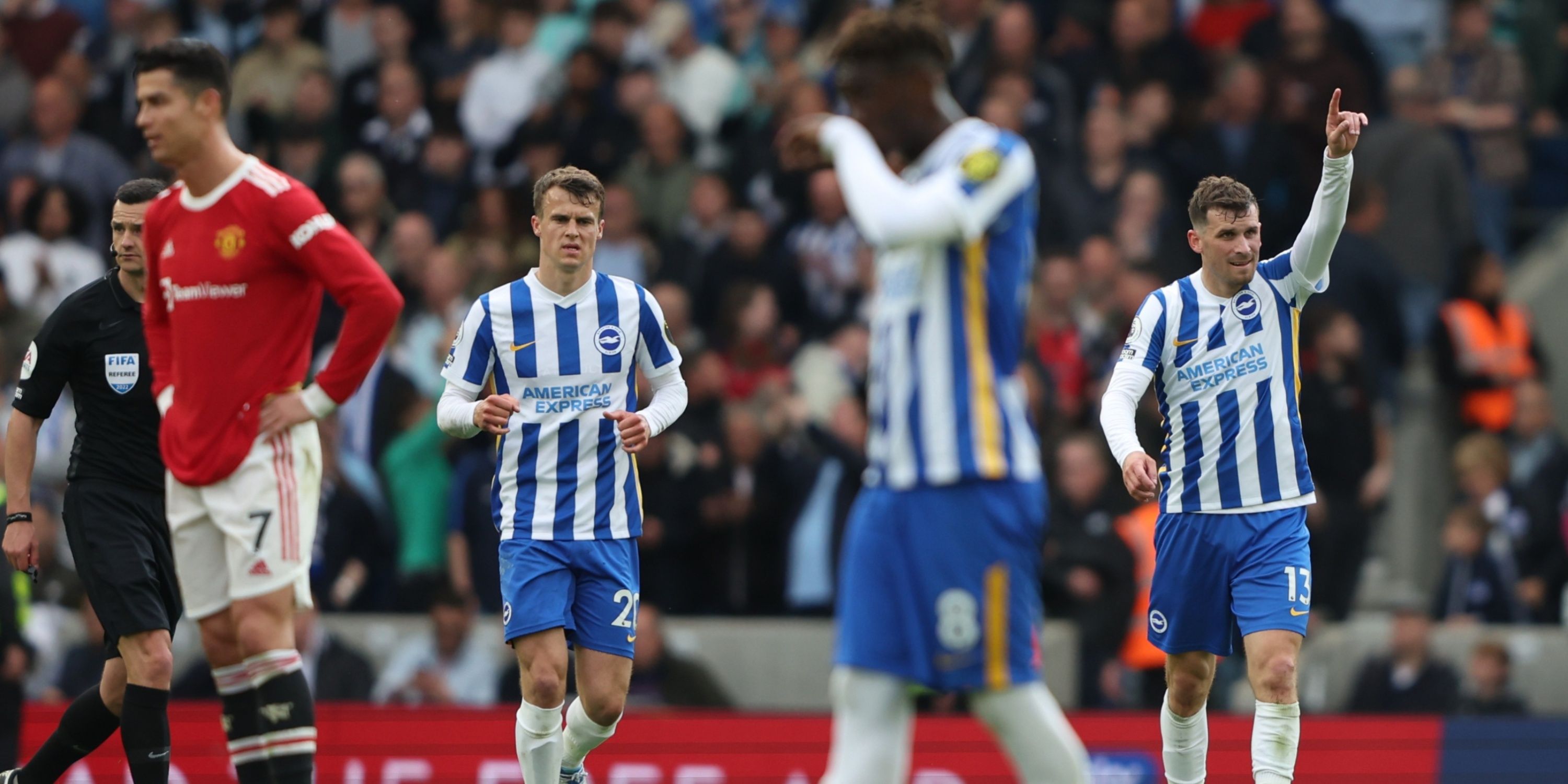 Brighton's Pascal Gross celebrates scoring while a despondent Cristiano Ronaldo looks on.