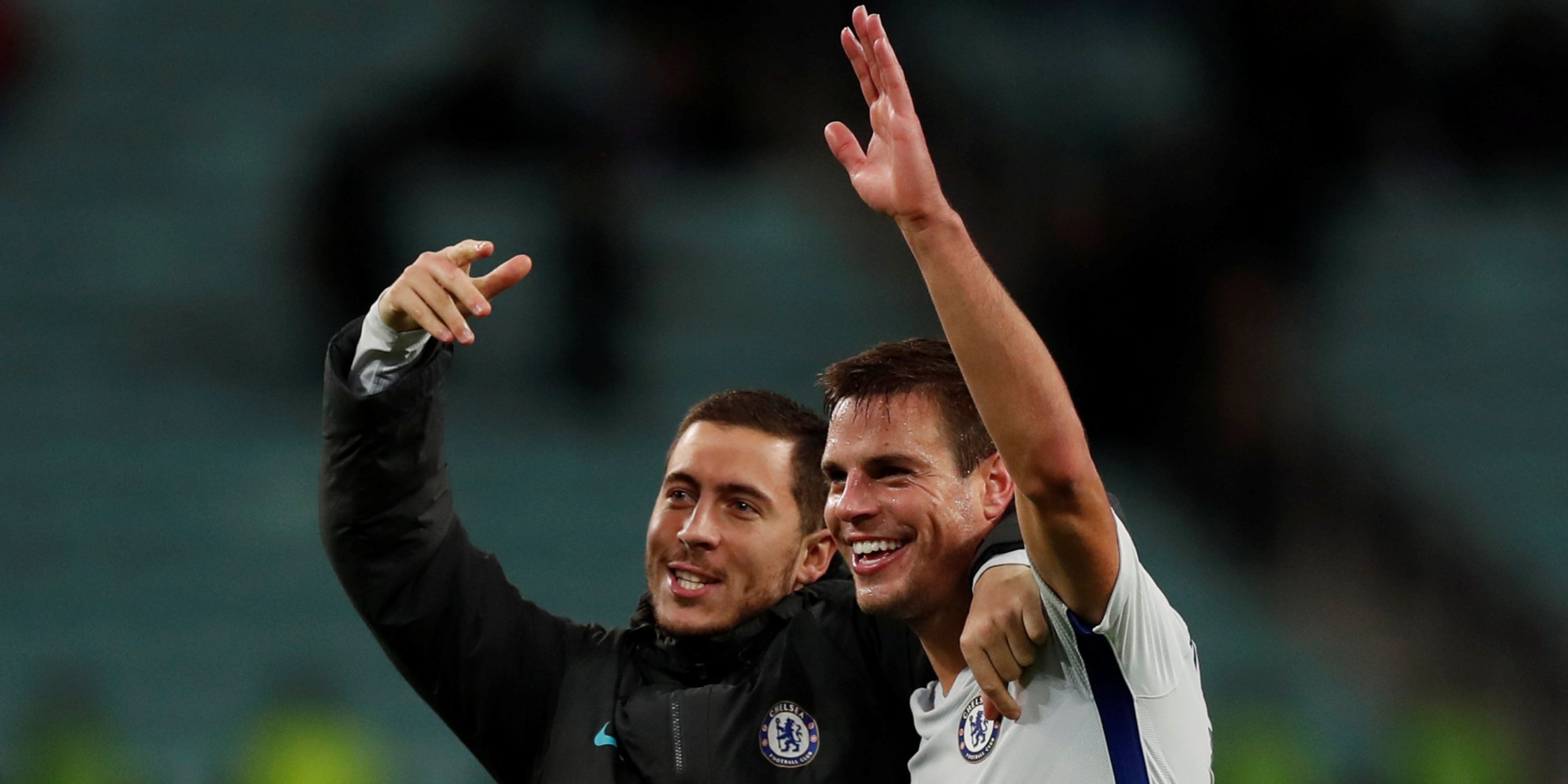 Chelsea teammates Eden Hazard and Cesar Azpilicueta wave to their supporters.
