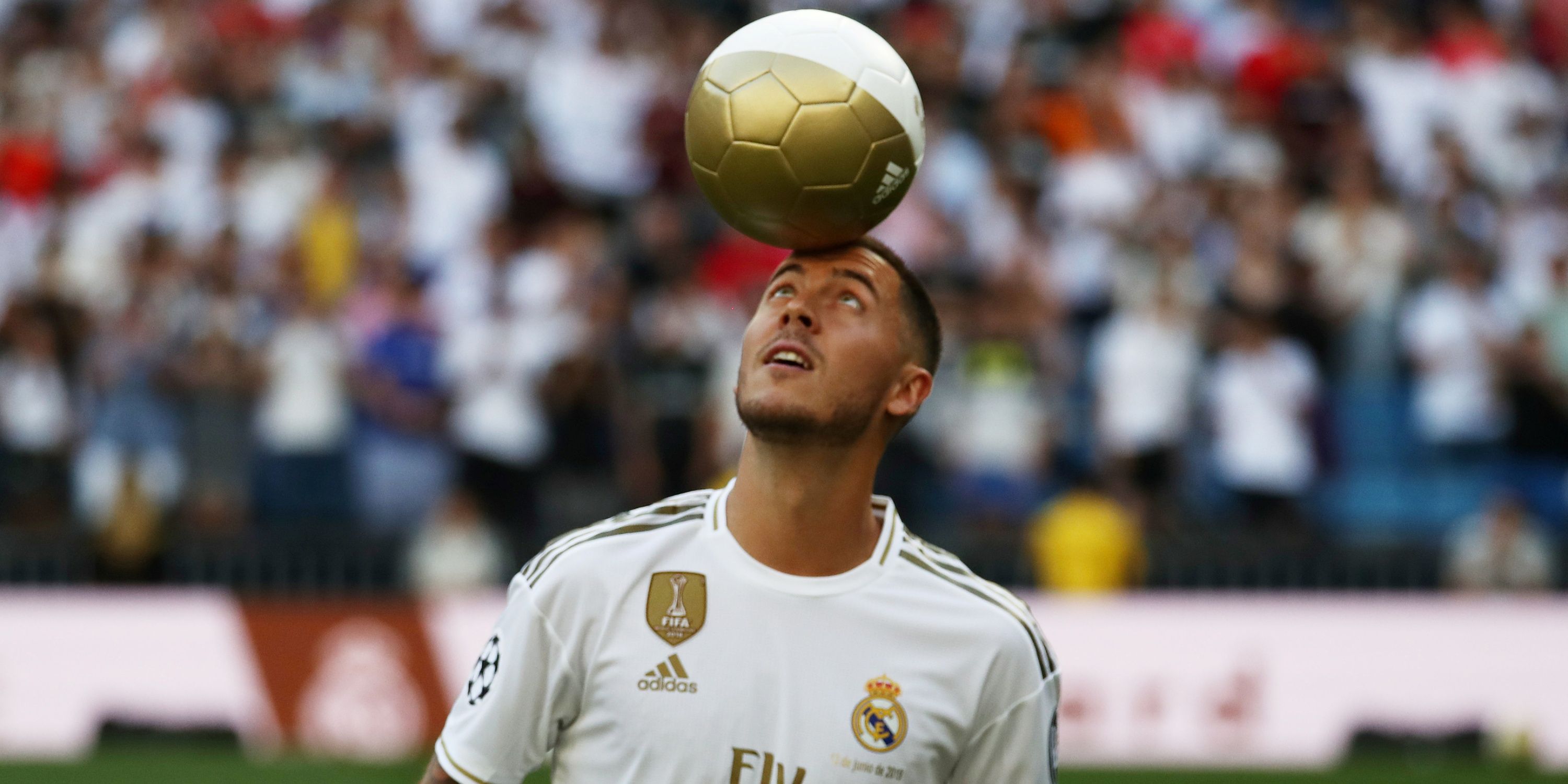 Eden Hazard balances the ball on his head at his unveiling as a Real Madrid player.