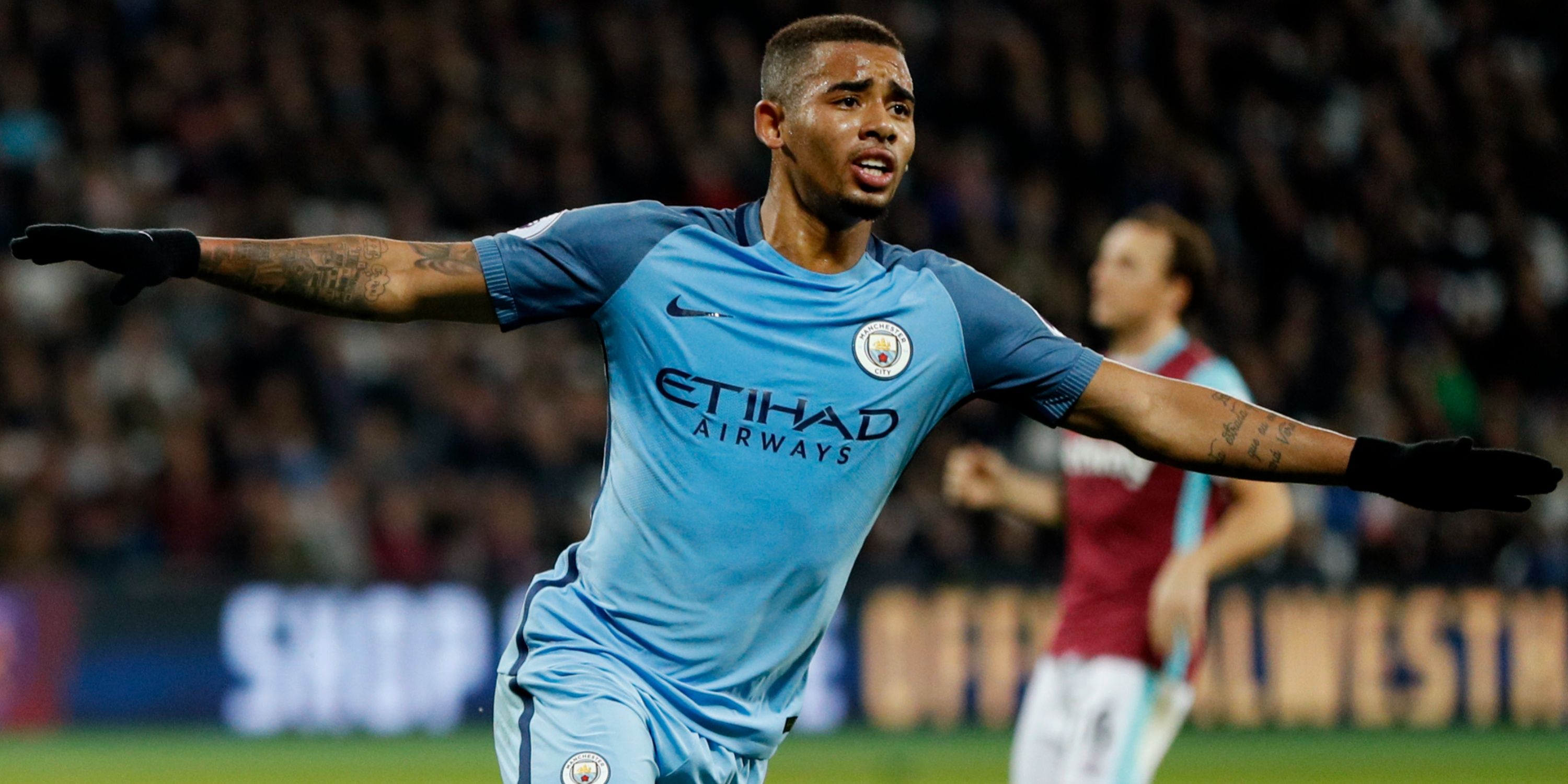 Manchester City's Gabriel Jesus celebrates scoring with outstretched arms. 