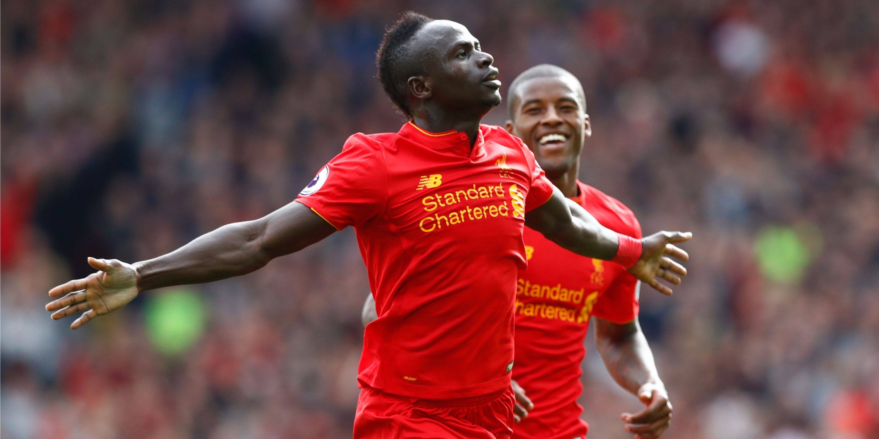 Liverpool players Sadio Mane and Georginio Wijnaldum celebrate a goal together. 