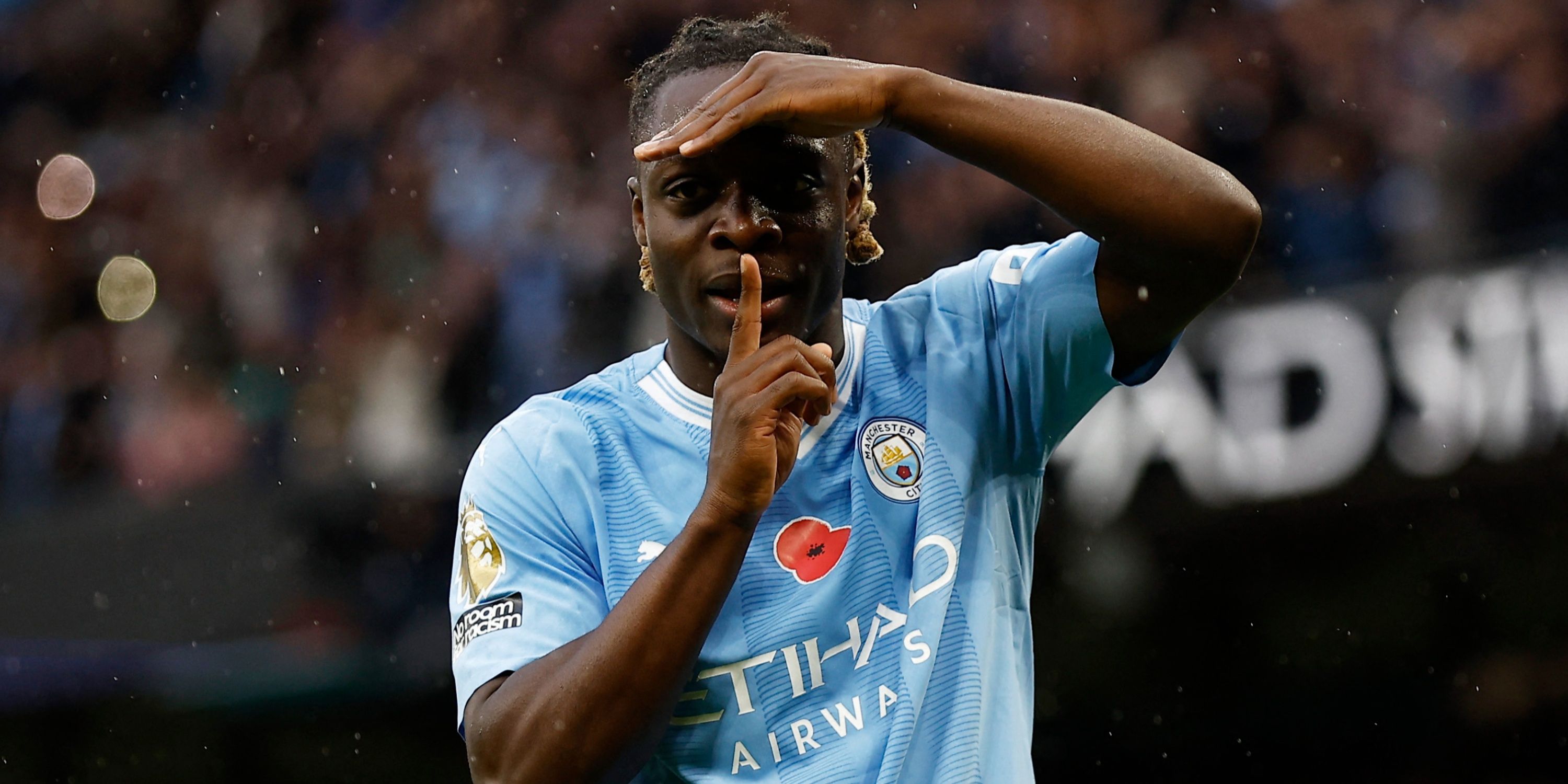 Jeremy Doku celebrates scoring a goal for Manchester City. 