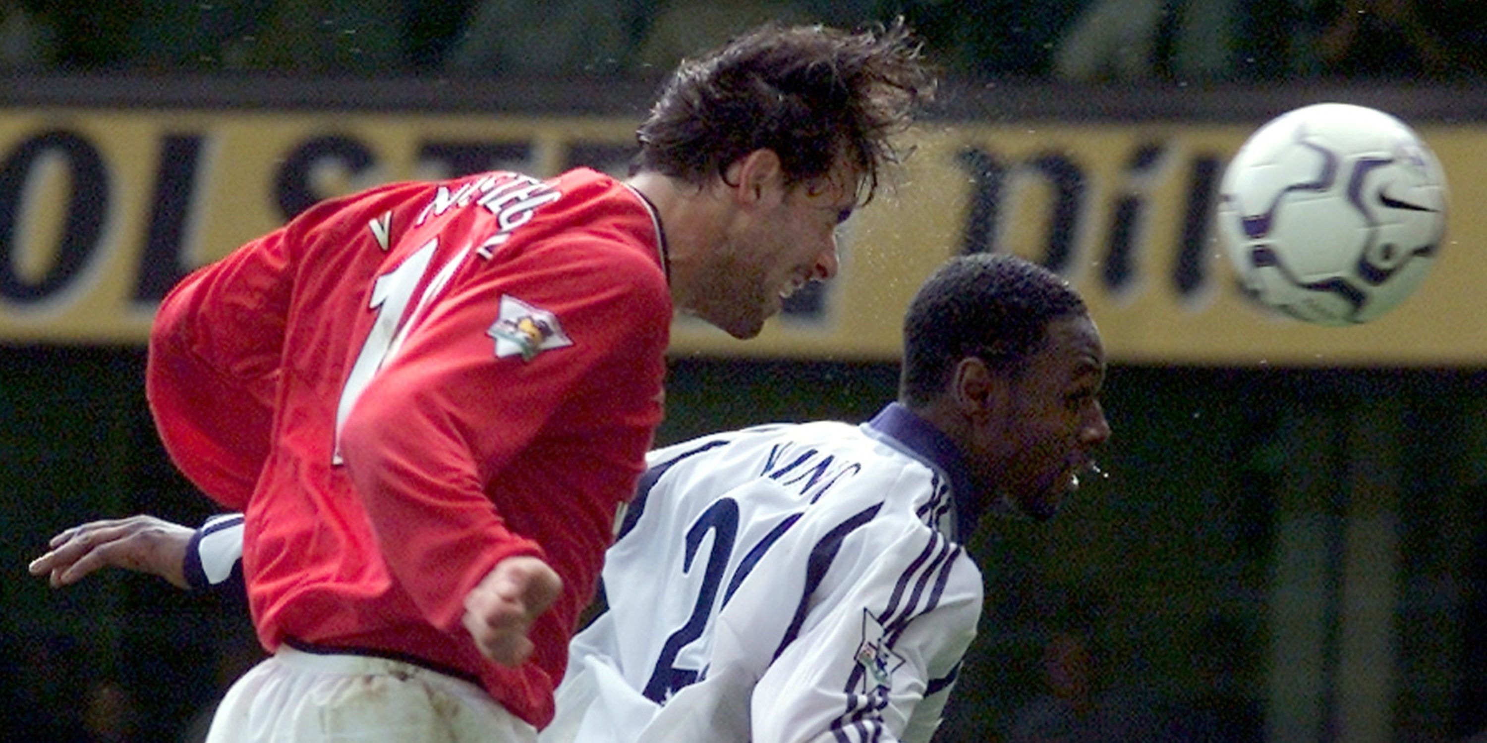 Manchester United's Ruud Van Nistelrooy (L) produces a header to score in front of Tottenham Hotspur's Ledley King